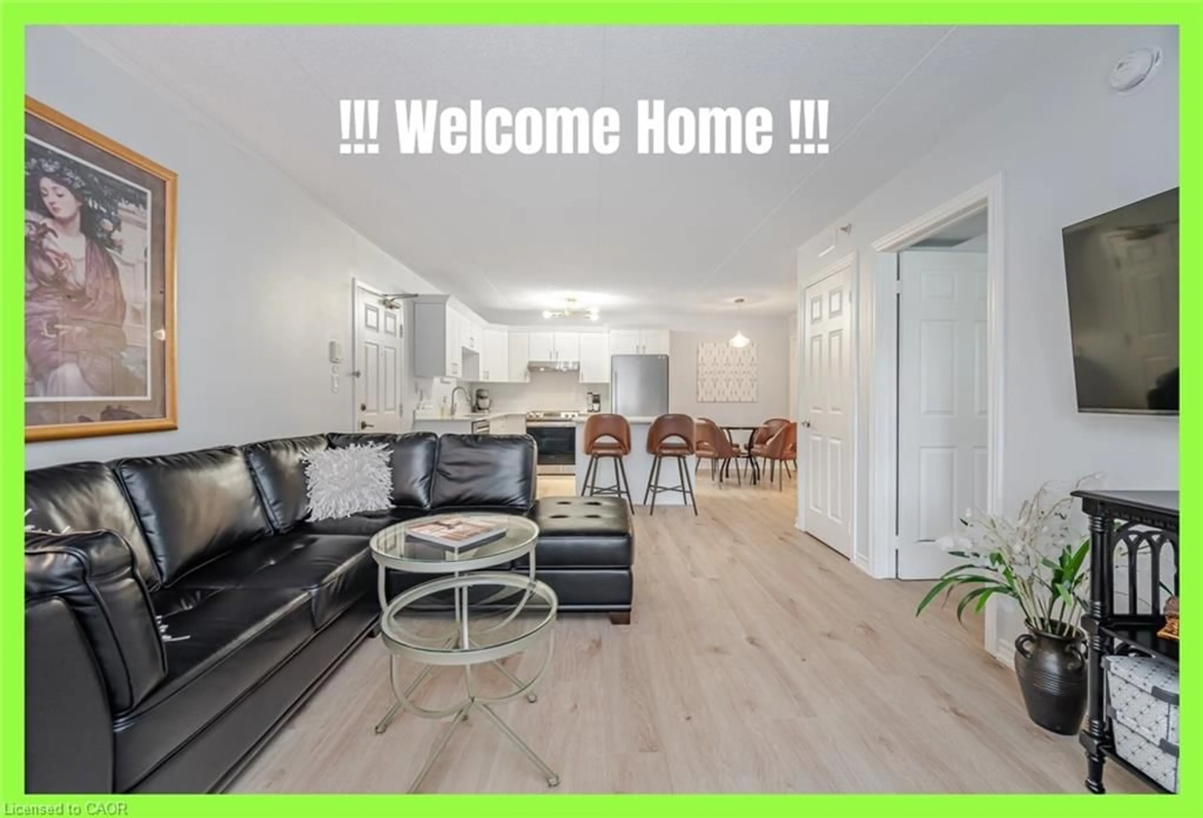 Living room with furniture, wood/laminate floor for 4005 Kilmer Dr #104, Burlington Ontario L7M 4M2