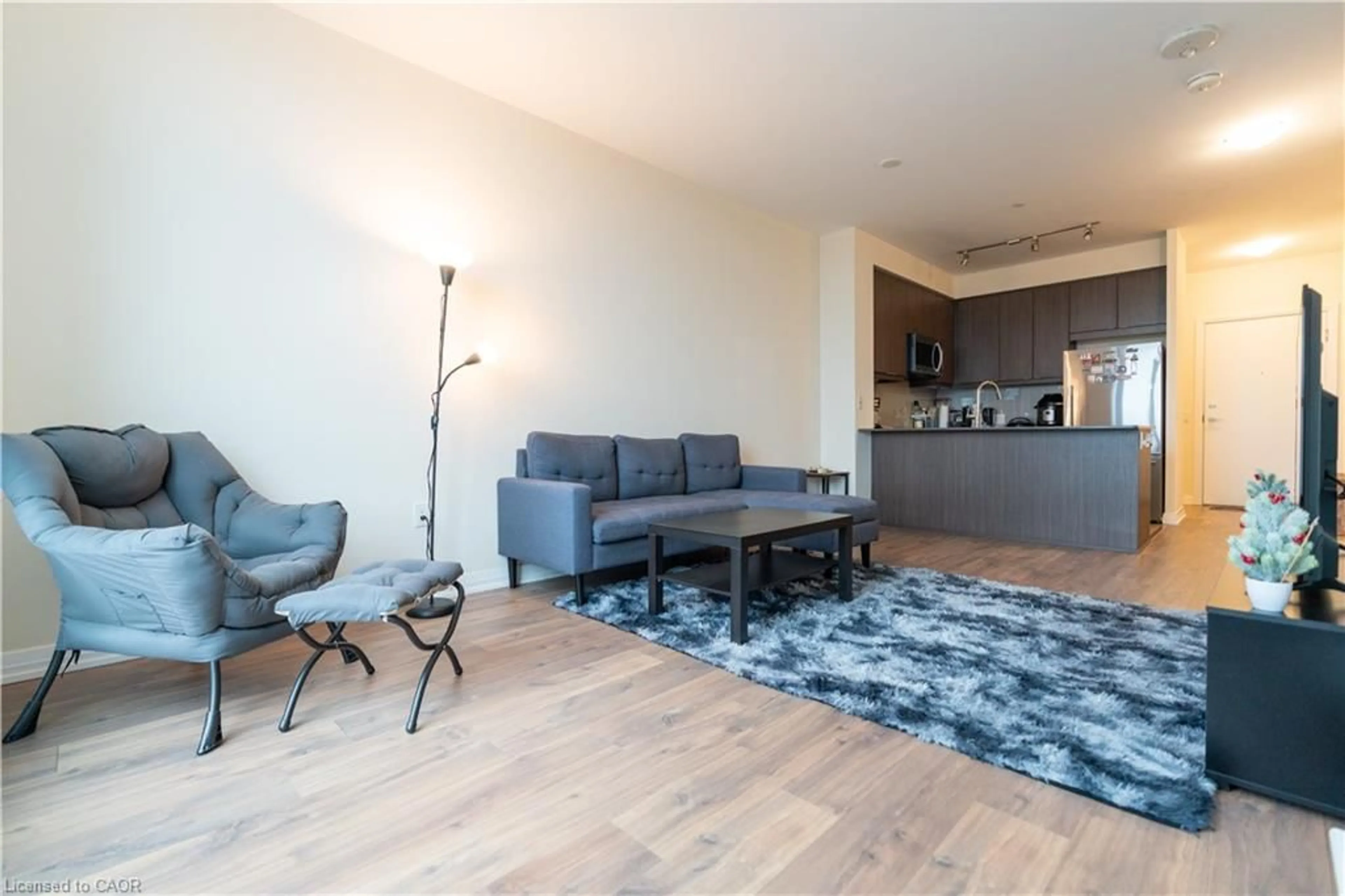 Living room with furniture, wood/laminate floor for 50 Thomas Riley Rd #207, Toronto Ontario M9B 0C5