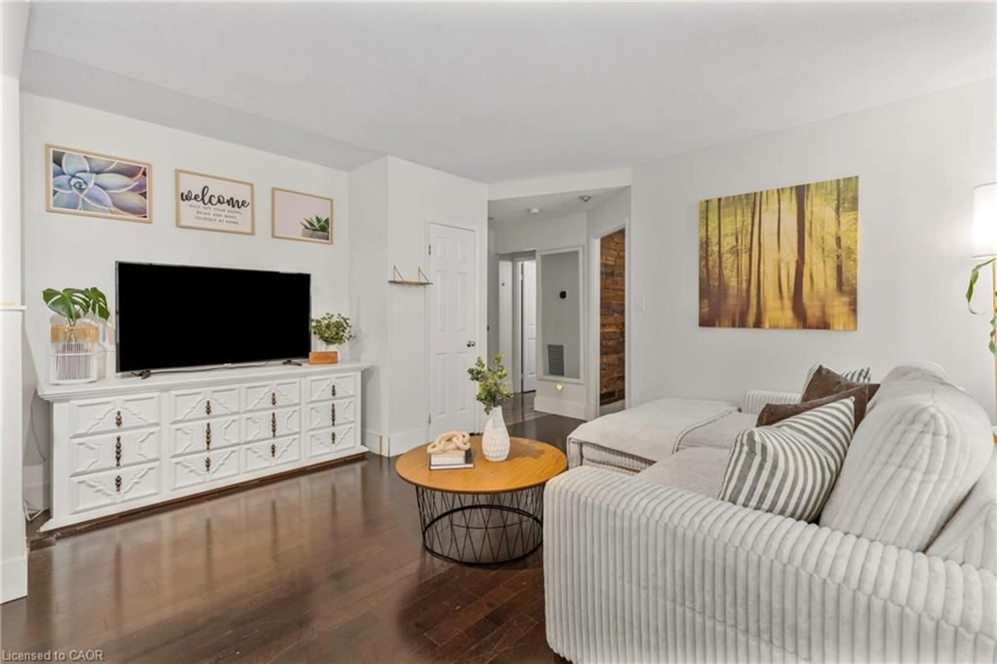 Living room with furniture, wood/laminate floor for 36 James St #803, Hamilton Ontario L8P 4W4