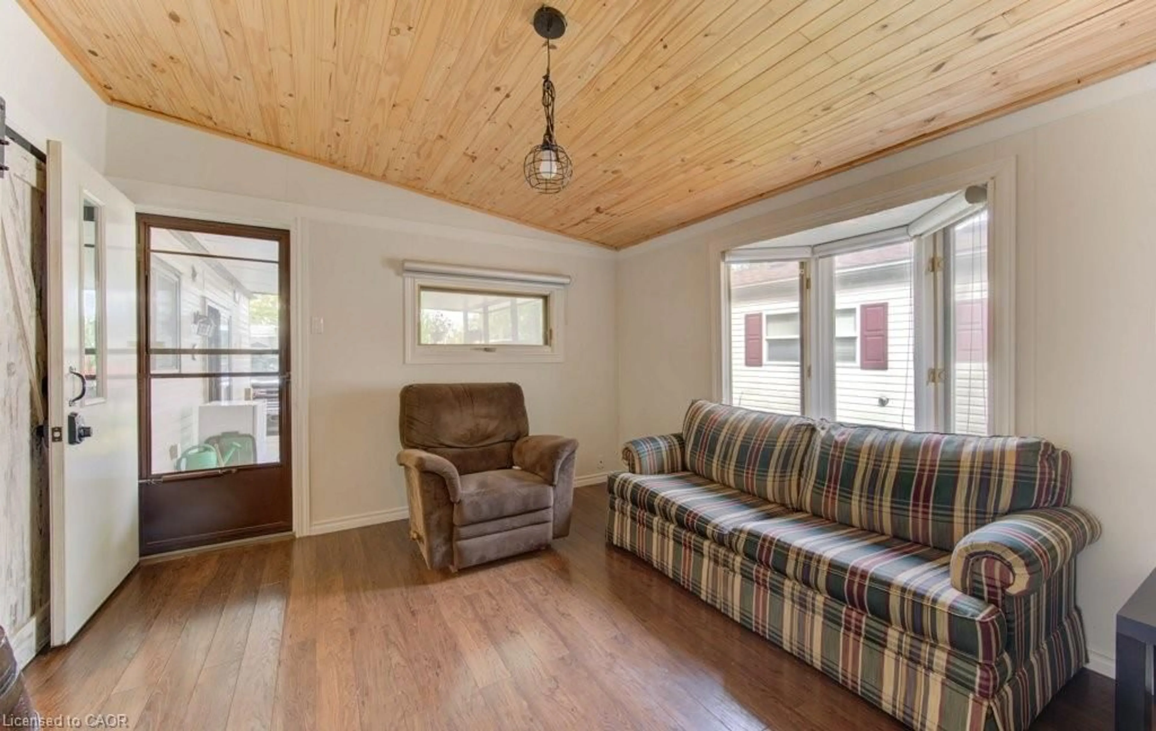 Living room with furniture, wood/laminate floor for 580 Beaver Creek Rd #206, Waterloo Ontario N2J 3Z4
