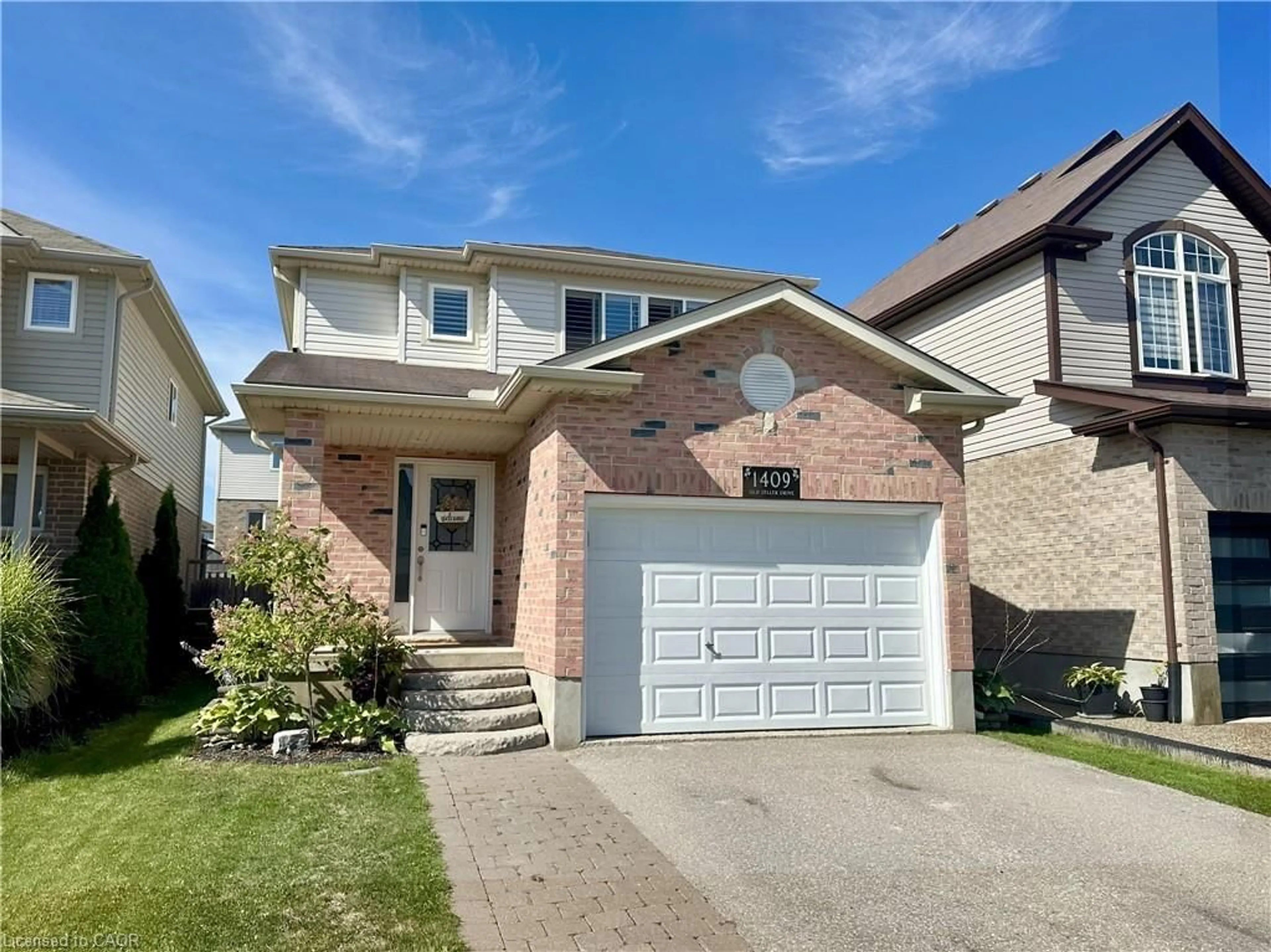 Home with brick exterior material, street for 1409 Old Zeller Dr, Kitchener Ontario N2A 4M8