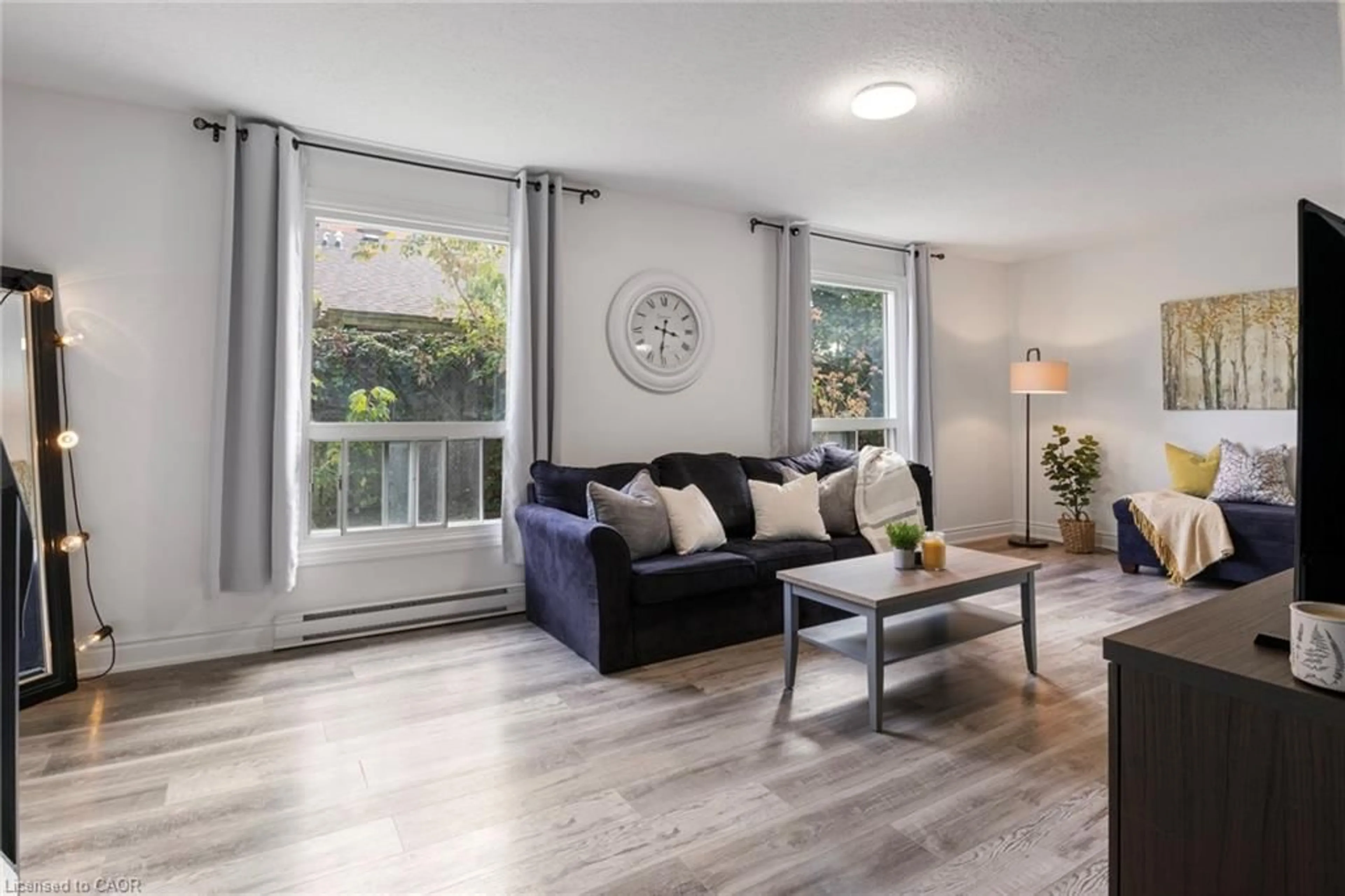 Living room with furniture, wood/laminate floor for 766 Walter St #D, Cambridge Ontario N3H 4P3