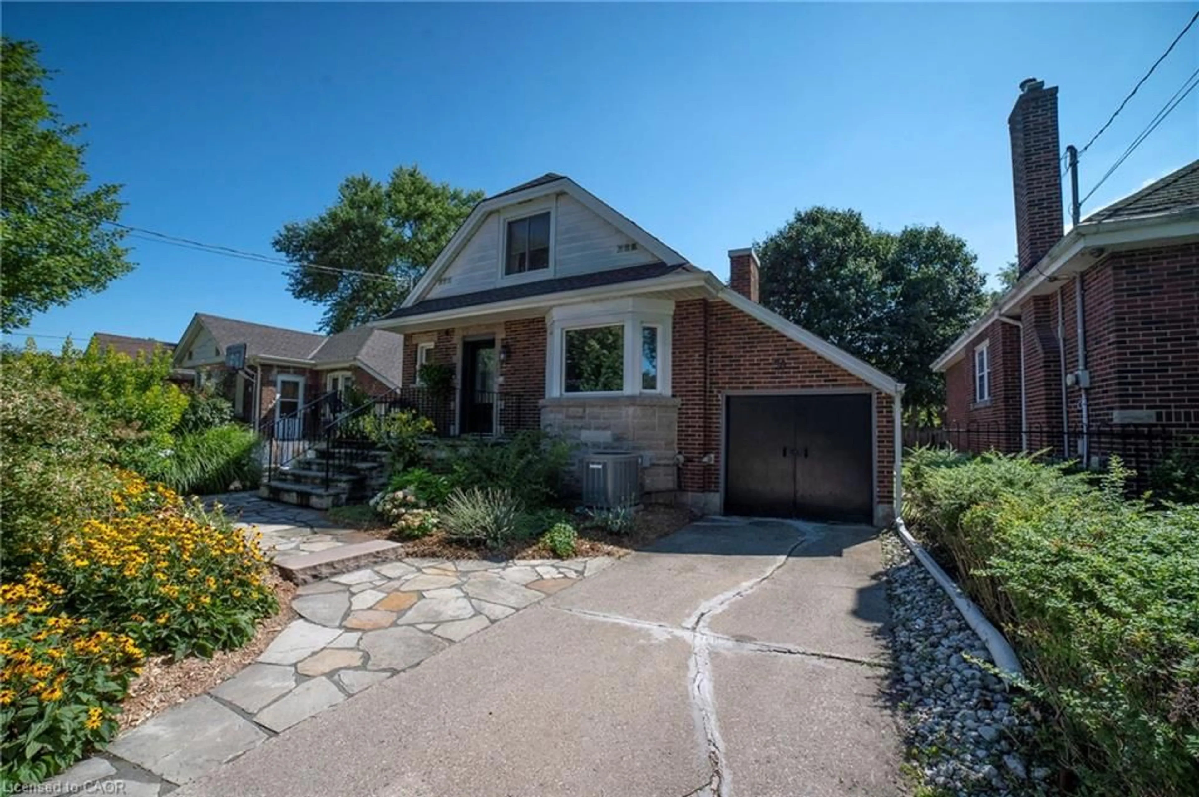 Home with brick exterior material, street for 38 Kenmore Rd, Hamilton Ontario L8S 3T7