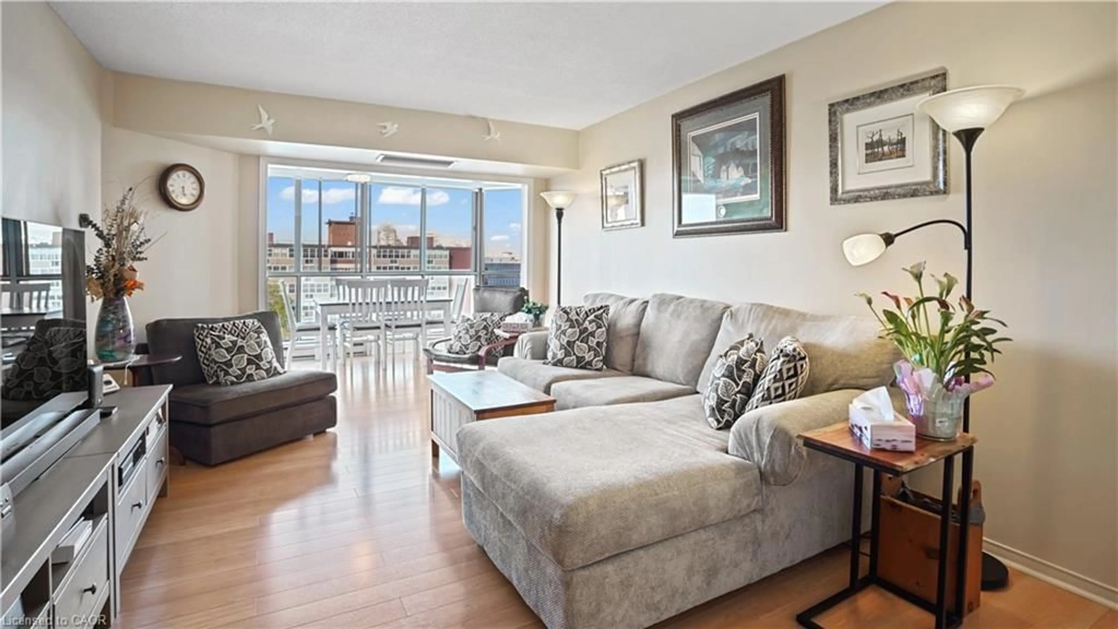 Living room with furniture, wood/laminate floor for 265 Westcourt Pl #705, Waterloo Ontario N2L 6E4