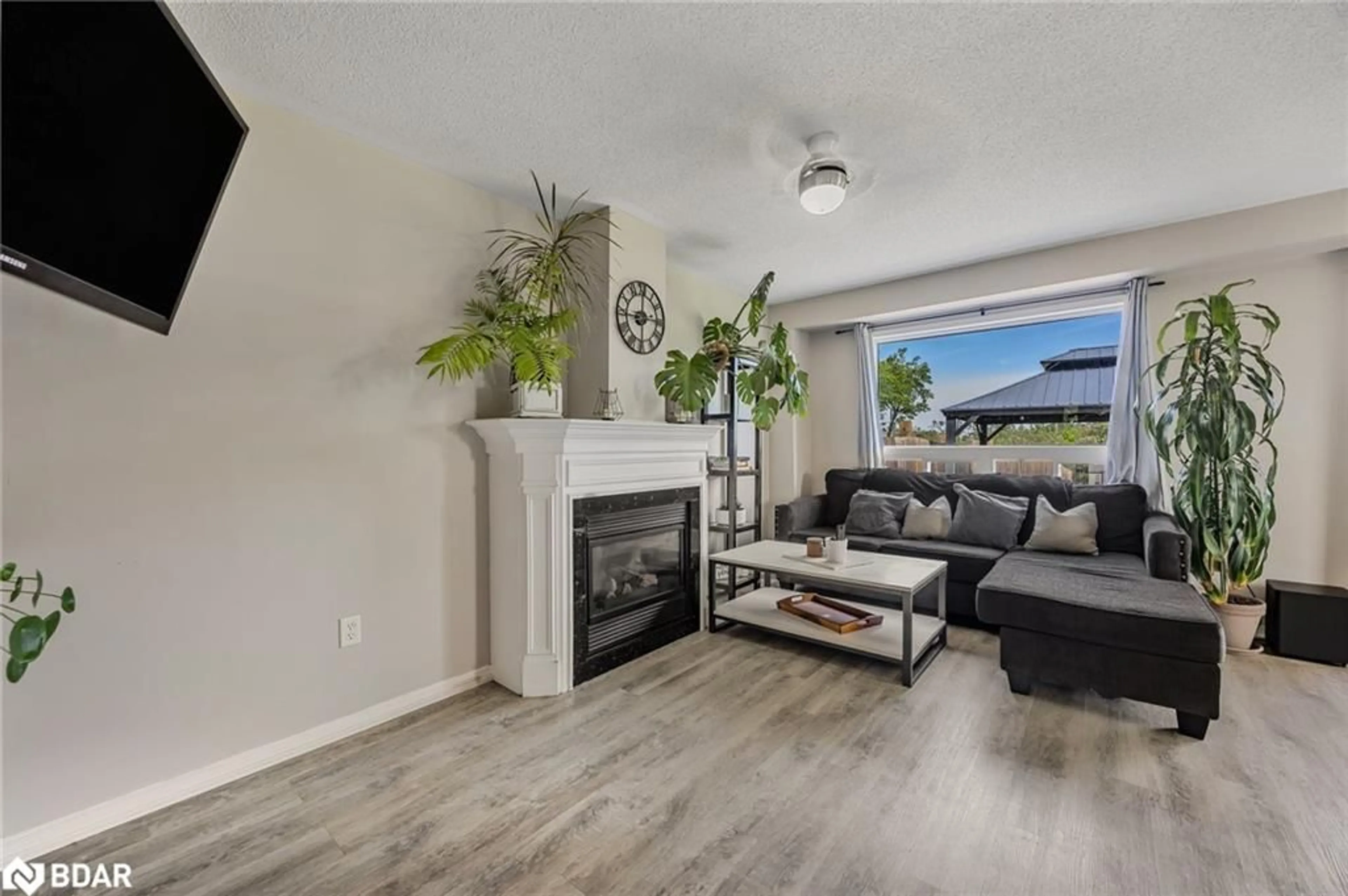 Living room with furniture, wood/laminate floor for 13 Sunset Pl, Barrie Ontario L4N 0T7
