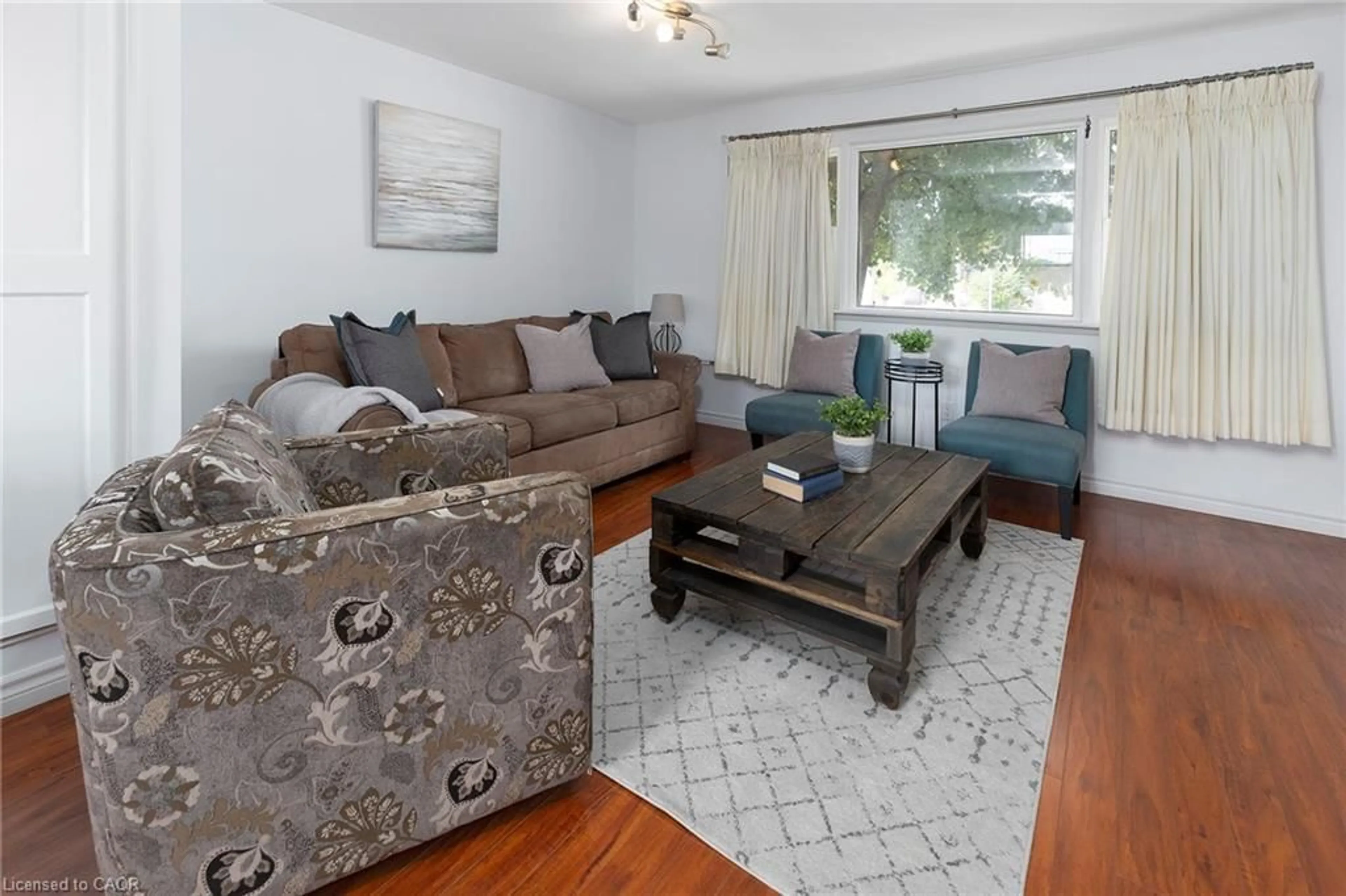 Living room with furniture, wood/laminate floor for 493 Upper Gage Ave, Hamilton Ontario L8V 4J2