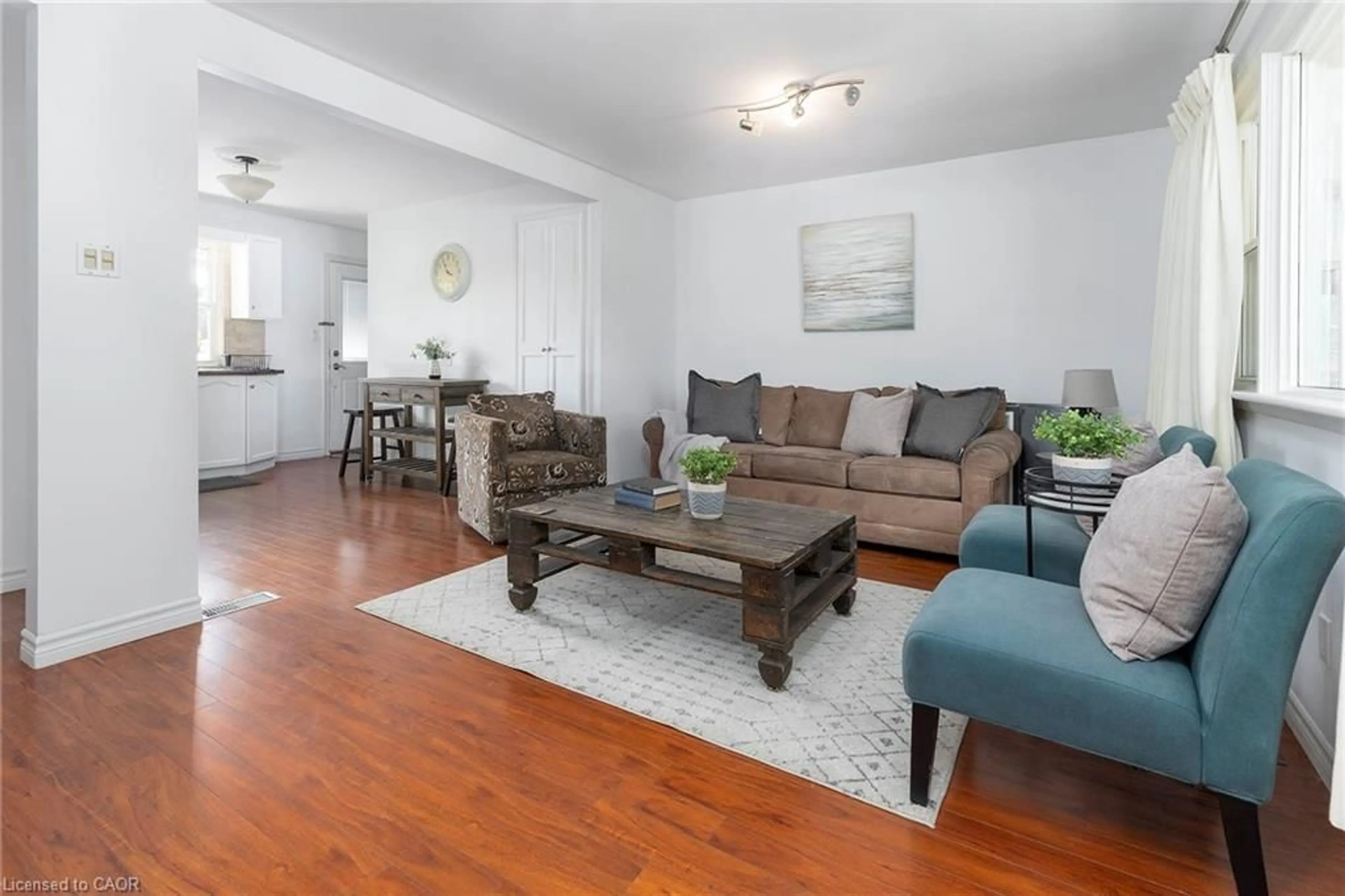 Living room with furniture, wood/laminate floor for 493 Upper Gage Ave, Hamilton Ontario L8V 4J2