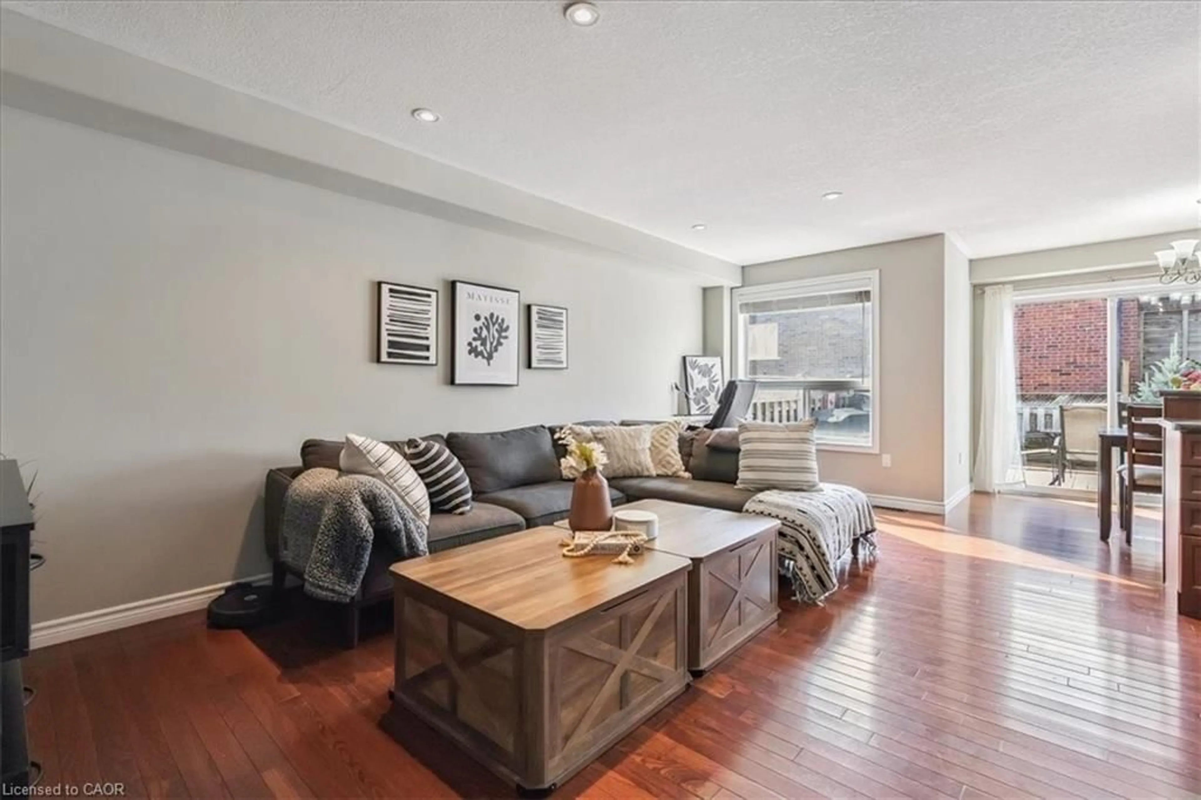 Living room with furniture, wood/laminate floor for 35 Pettit St, Stoney Creek Ontario L8E 5V7