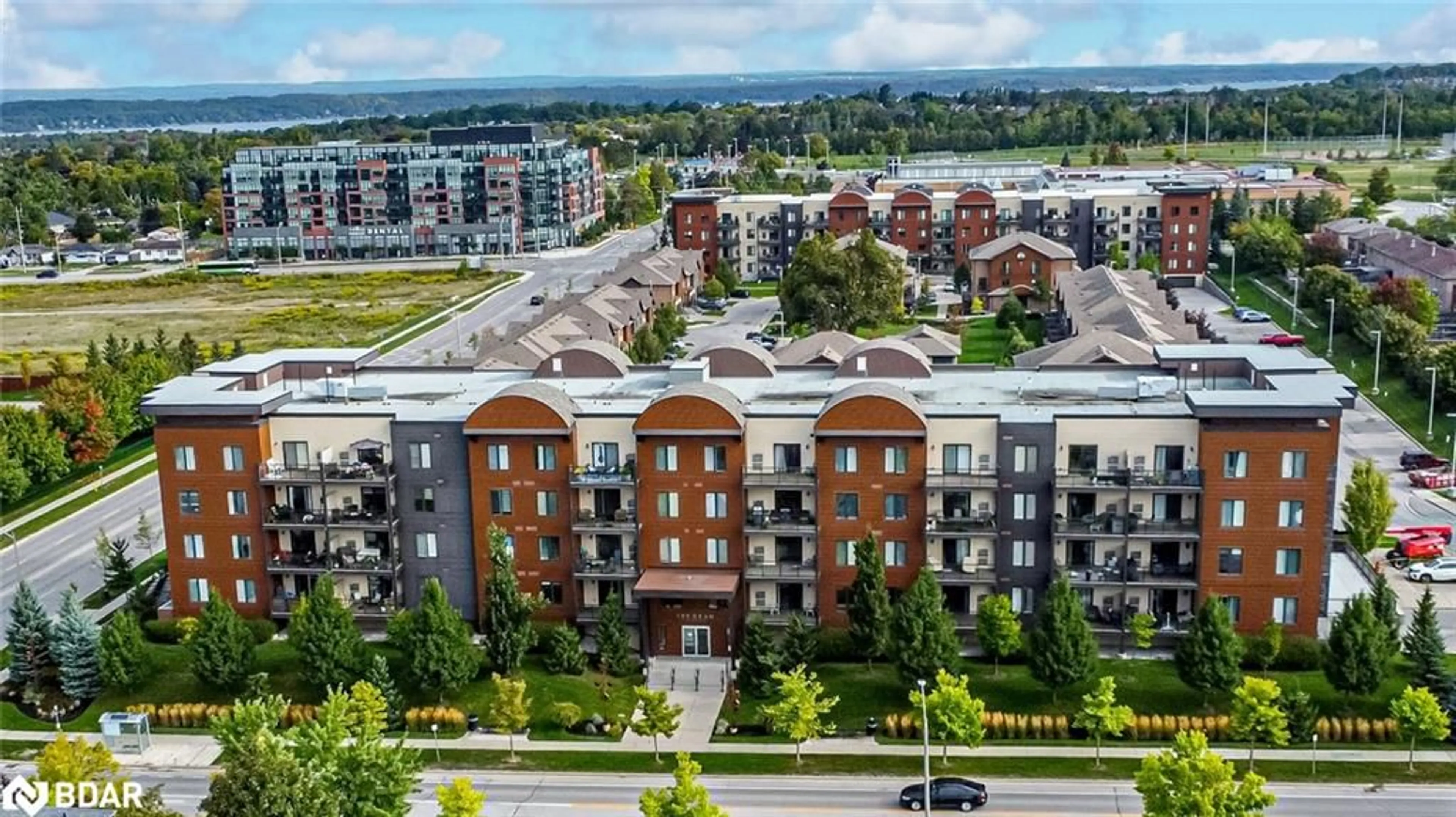 A pic from outside/outdoor area/front of a property/back of a property/a pic from drone, city buildings view from balcony for 100 Dean Ave #110, Barrie Ontario L9J 0H1