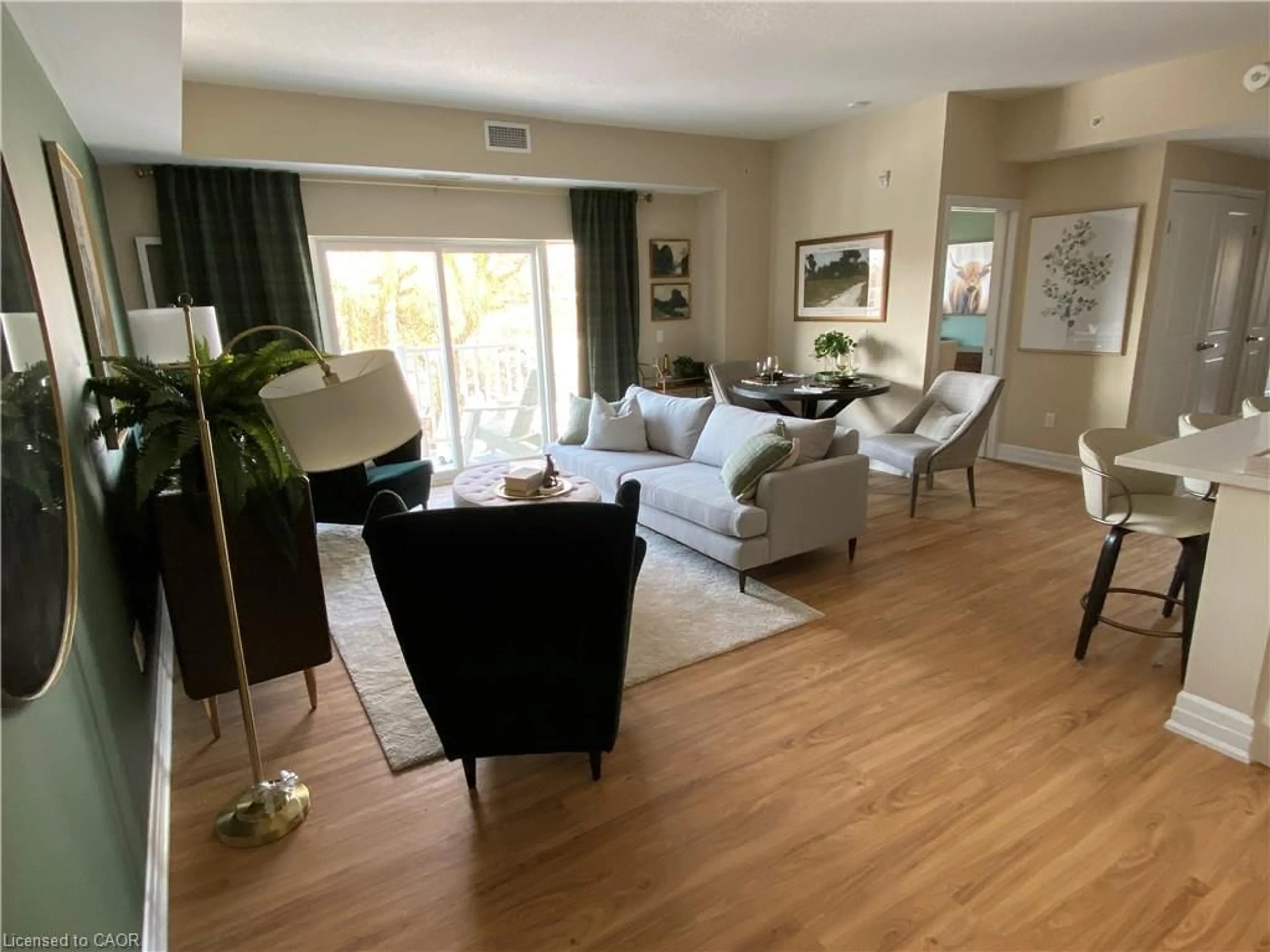 Living room with furniture, wood/laminate floor for 39 Sister Varga Terr #115, Hamilton Ontario L9B 0J7