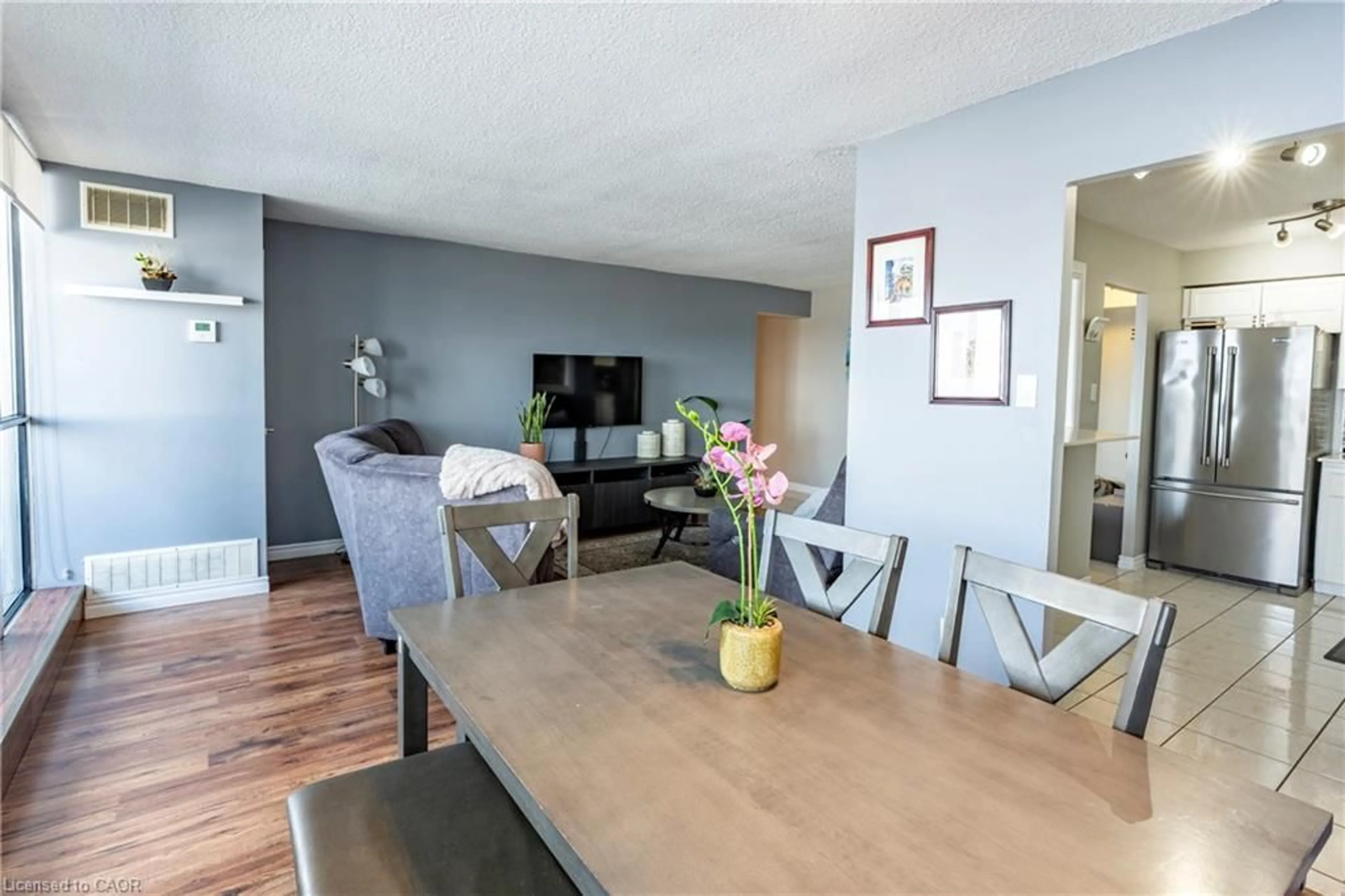 Living room with furniture, wood/laminate floor for 375 King St #2002, Waterloo Ontario N2J 4L6
