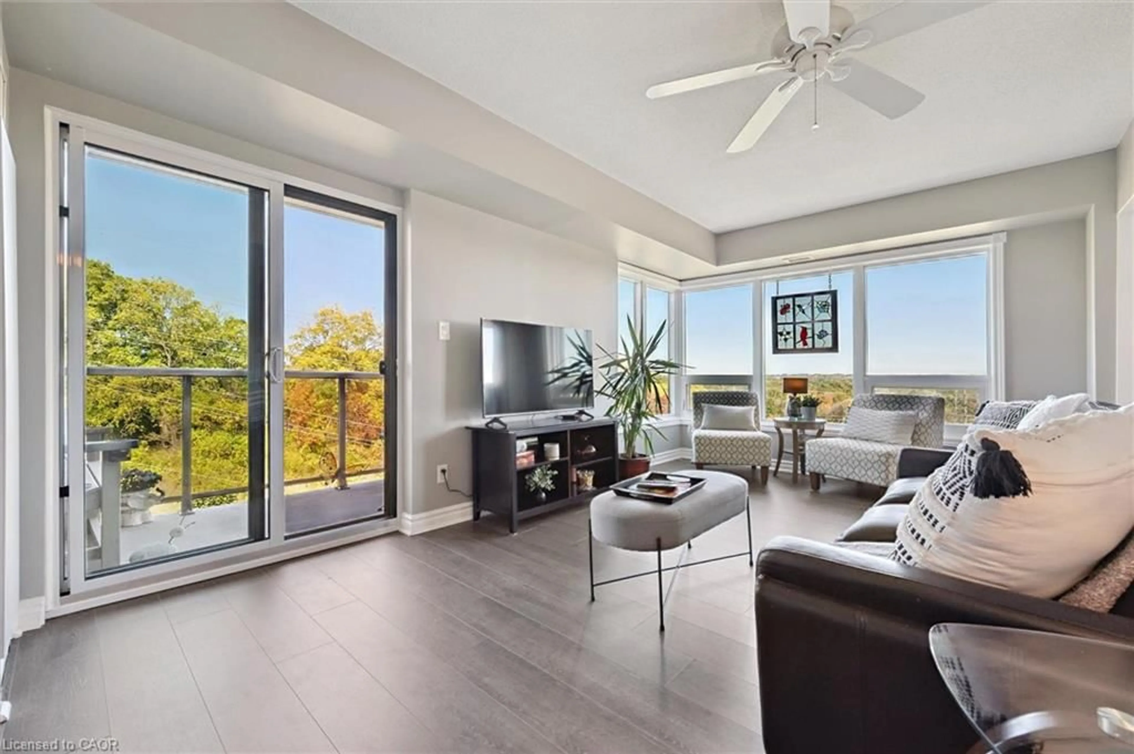 Living room with furniture, wood/laminate floor for 237 King St #703, Cambridge Ontario N3H 5L2