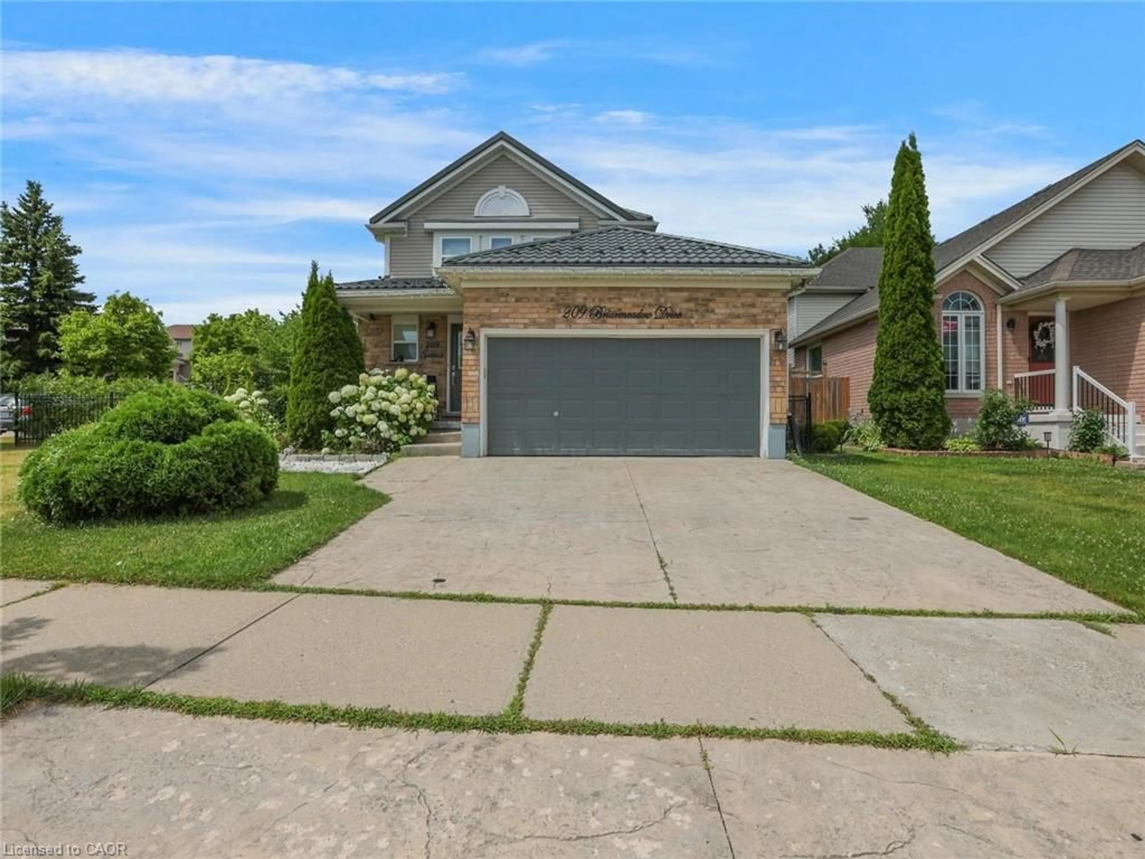 Home with brick exterior material, street for 209 Briarmeadow Dr, Kitchener Ontario N2A 4C5