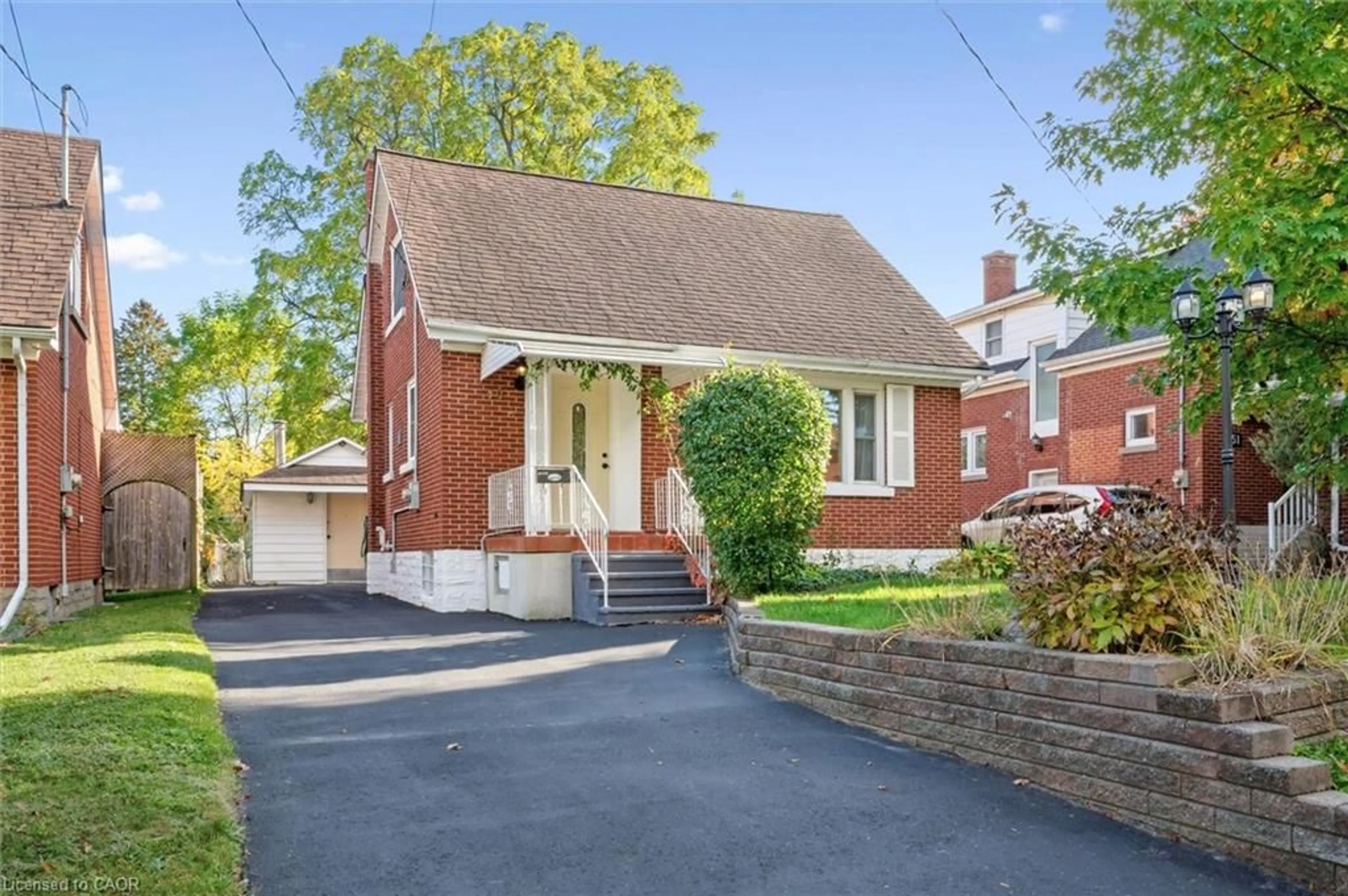 Home with brick exterior material, street for 49 Woodland Ave, Kitchener Ontario N2M 3G8