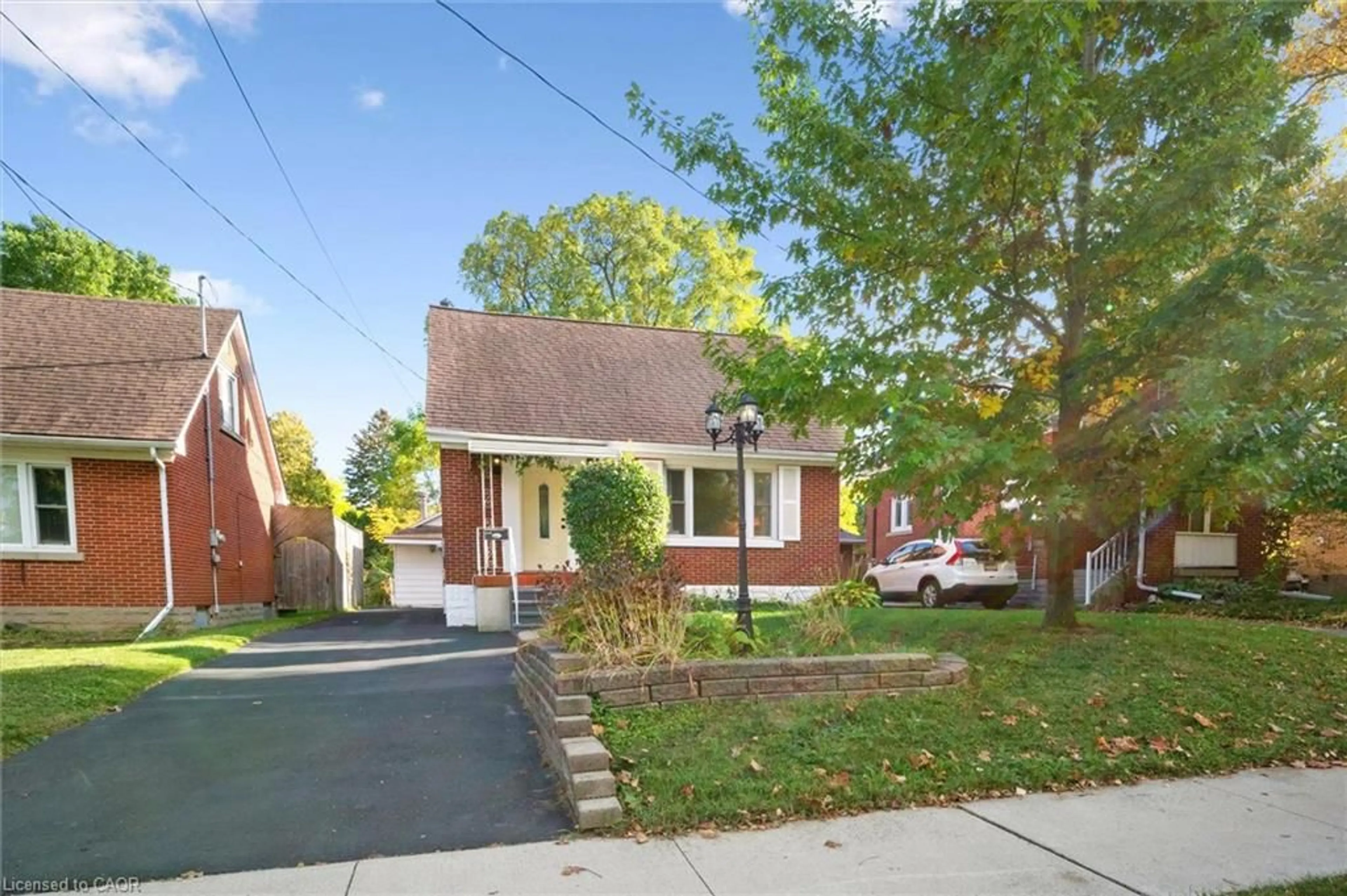 Home with brick exterior material, street for 49 Woodland Ave, Kitchener Ontario N2M 3G8