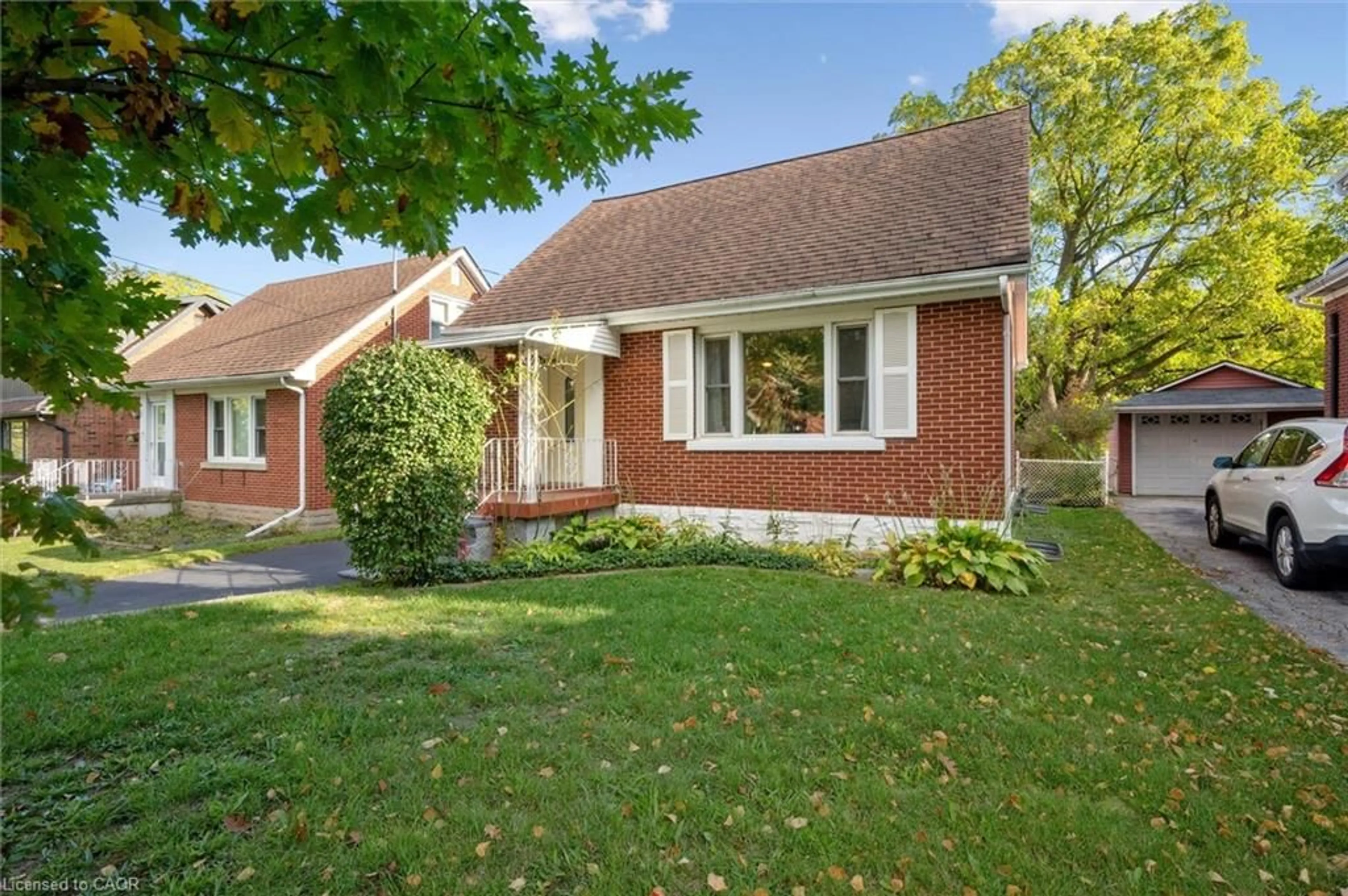 Home with brick exterior material, street for 49 Woodland Ave, Kitchener Ontario N2M 3G8