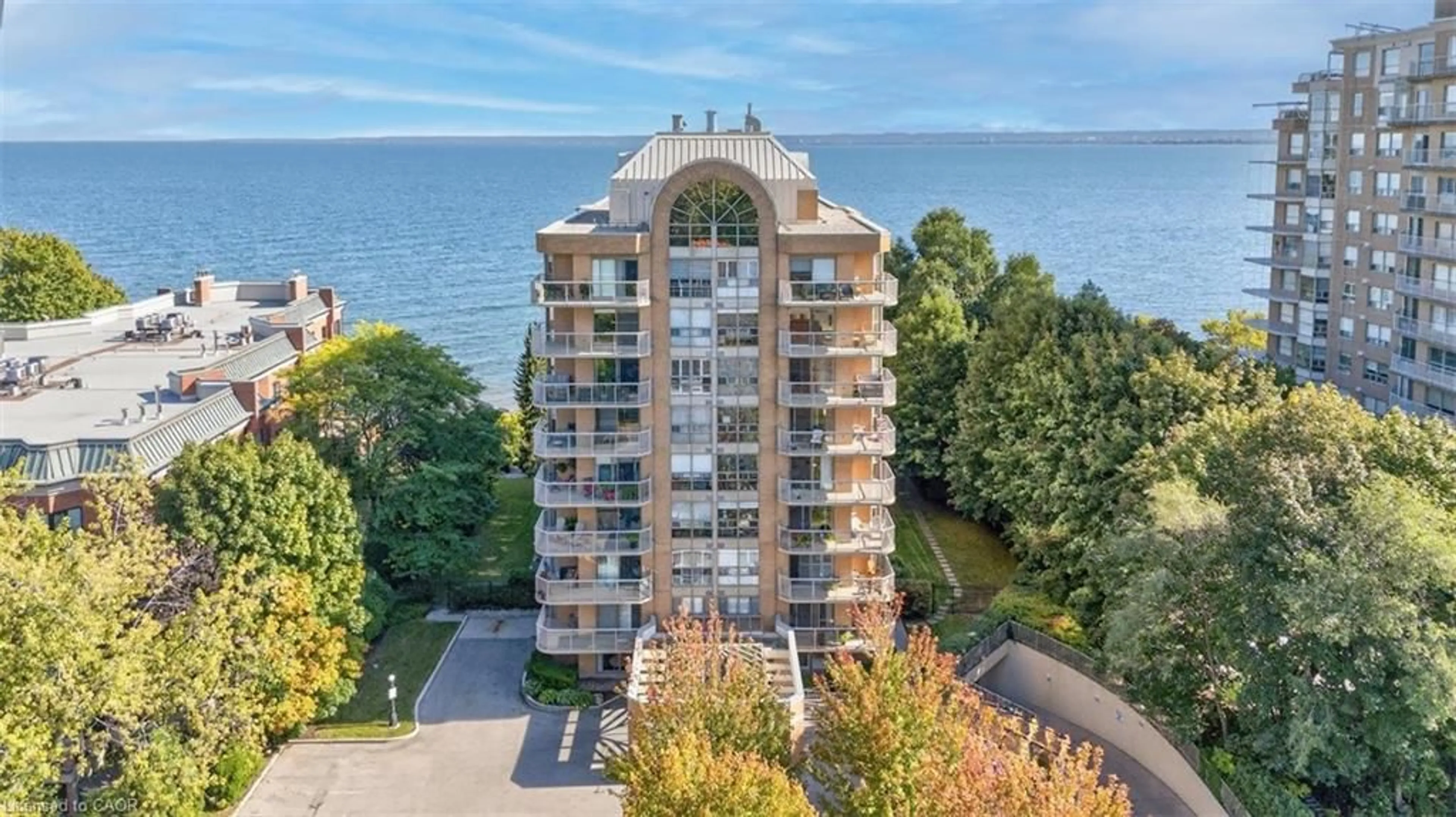 A pic from outside/outdoor area/front of a property/back of a property/a pic from drone, water/lake/river/ocean view for 2210 Lakeshore Rd #203, Burlington Ontario L7R 4J9