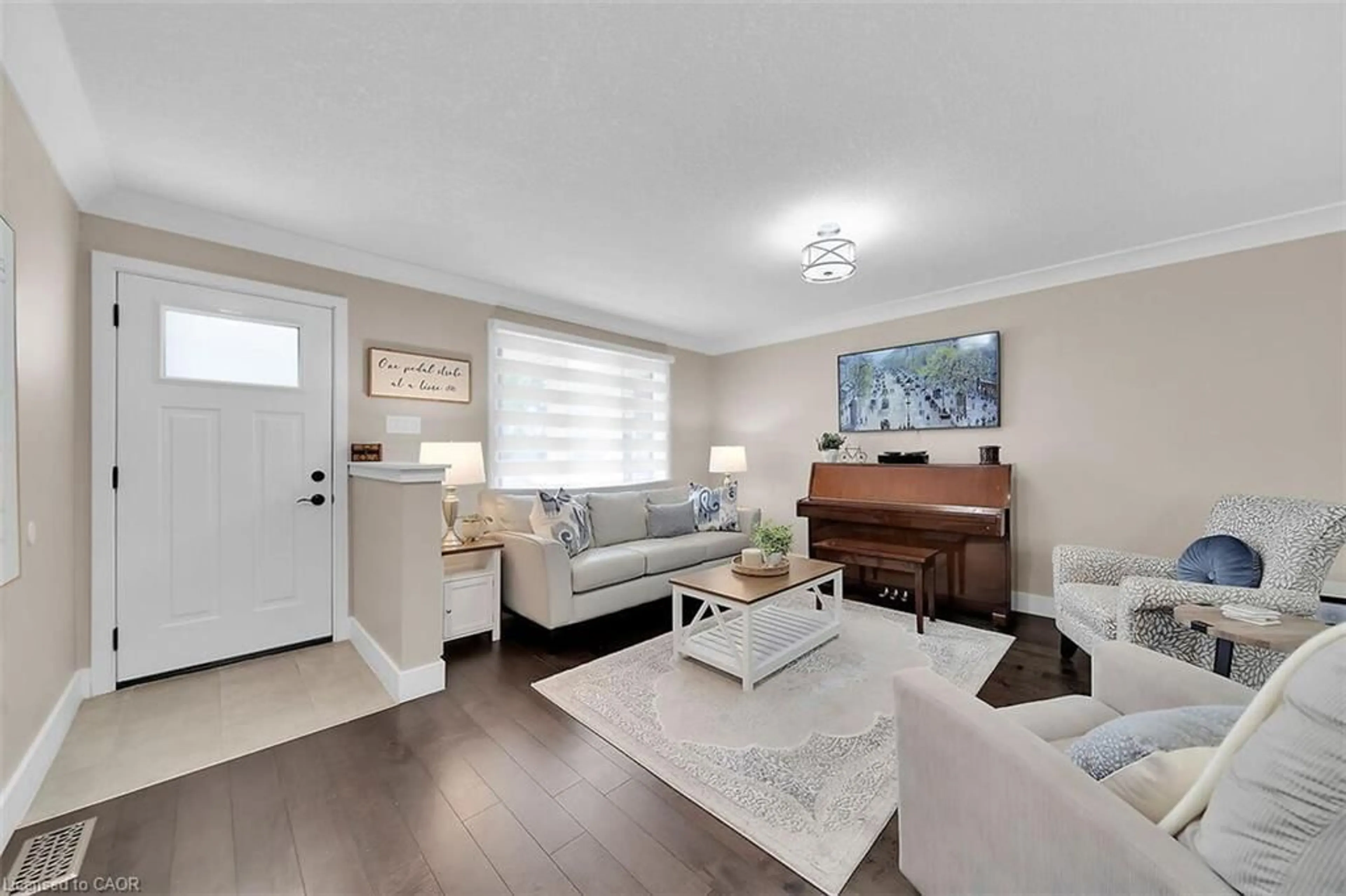 Living room with furniture, wood/laminate floor for 25 Celtic Dr, Caledonia Ontario N3W 2K3