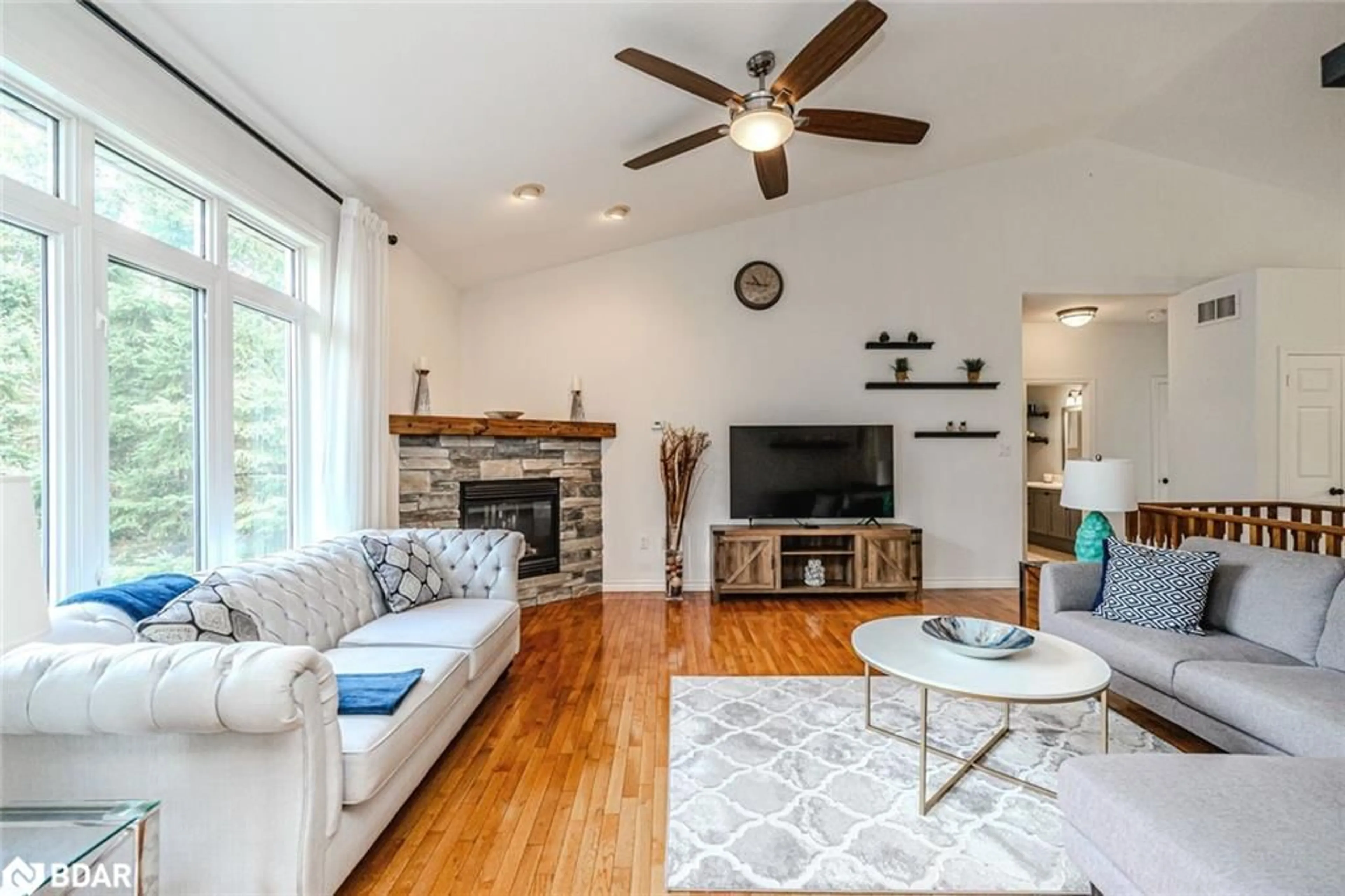 Living room with furniture, wood/laminate floor for 102 Highland Dr, Horseshoe Valley Ontario L0L 2L0