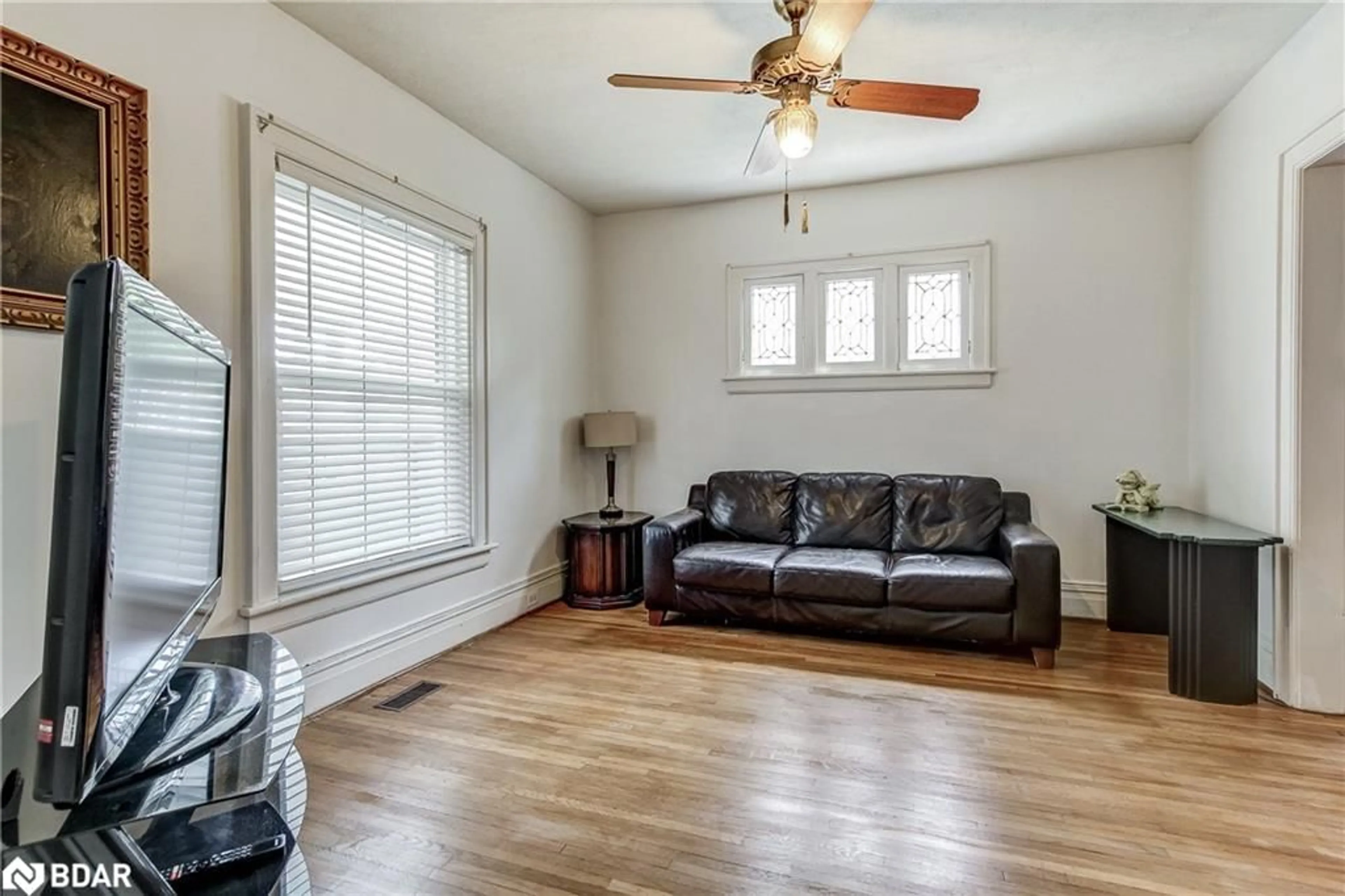 Living room with furniture, wood/laminate floor for 6062 Barker St, Niagara Falls Ontario L2G 1Y4