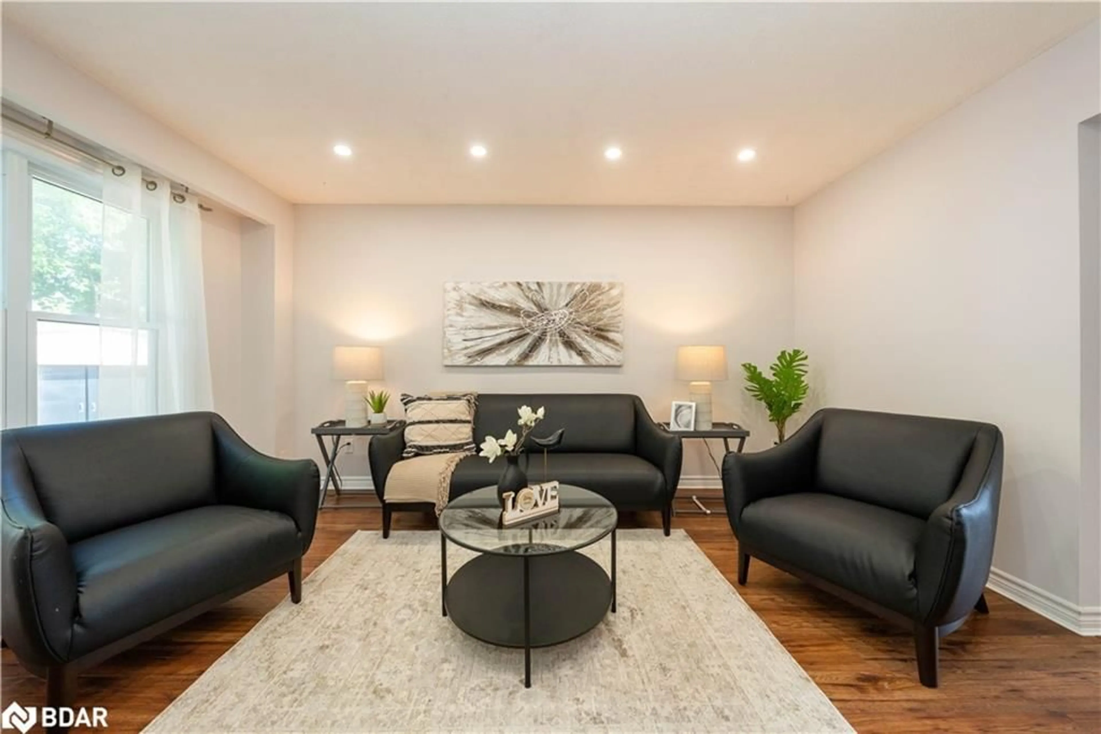 Living room with furniture, wood/laminate floor for 19 Burbank Cres, Orangeville Ontario L9W 3E6