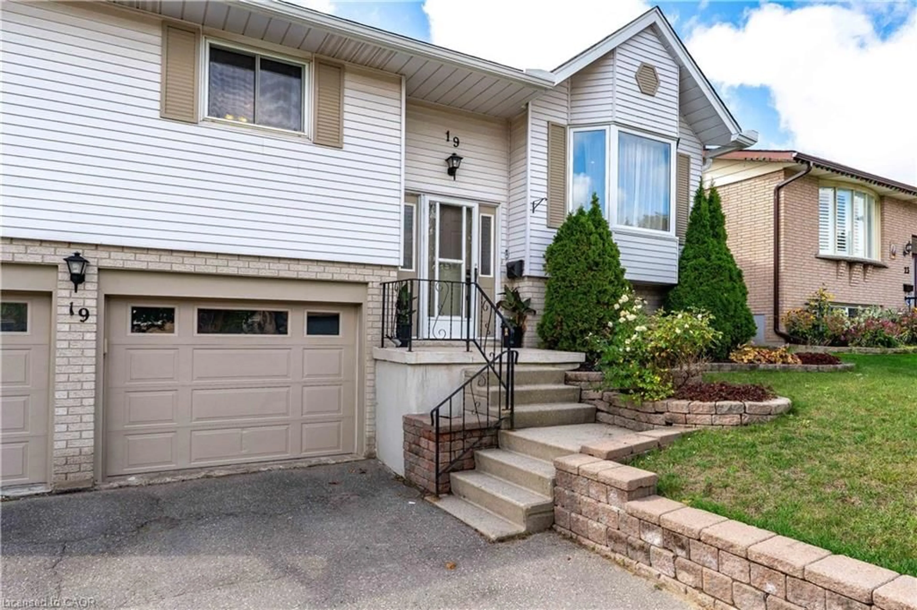 Home with vinyl exterior material, street for 19 Kesselring Dr, Kitchener Ontario N2E 2P3