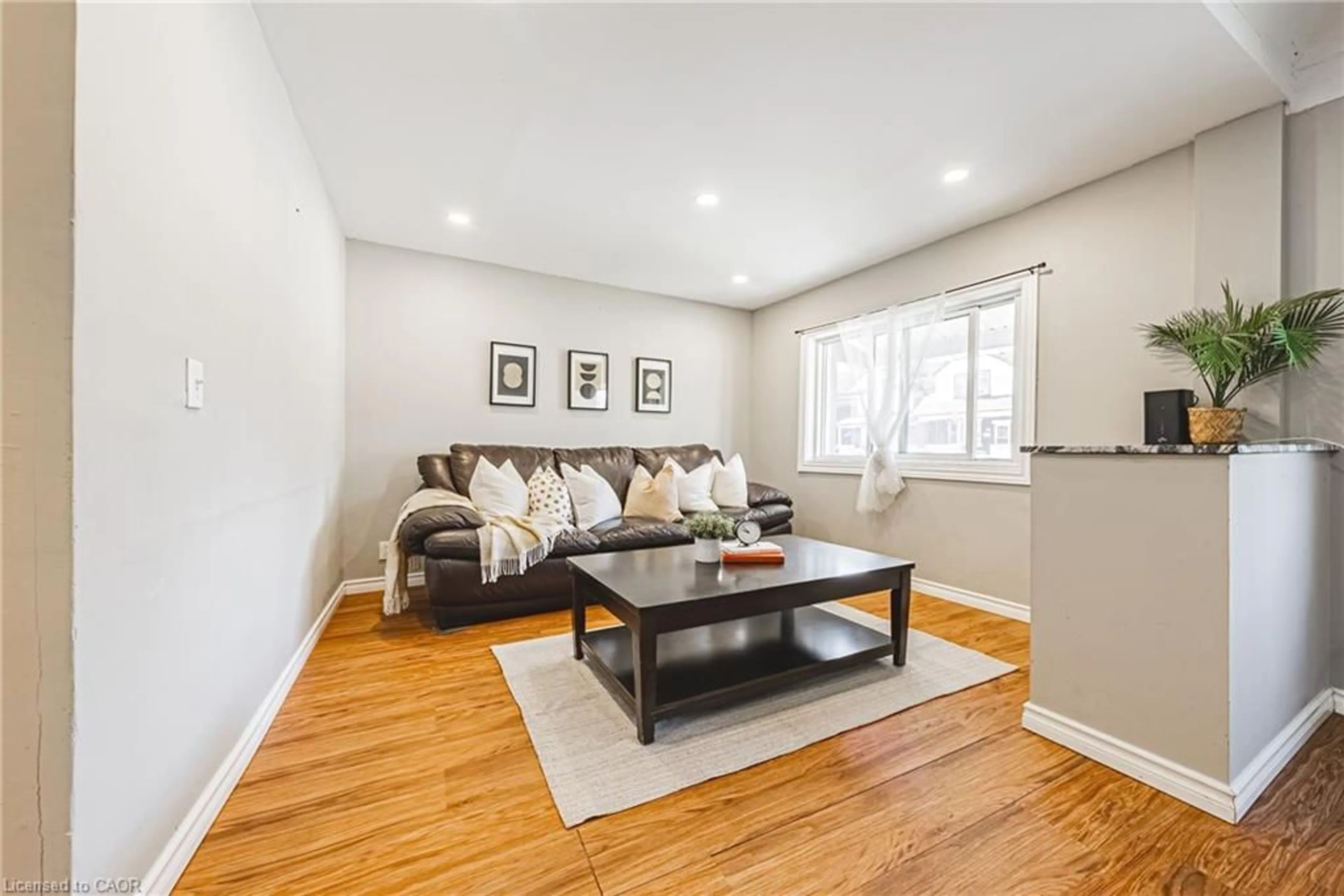 Living room with furniture, wood/laminate floor for 24 Rowanwood St, Hamilton Ontario L8L 7H3