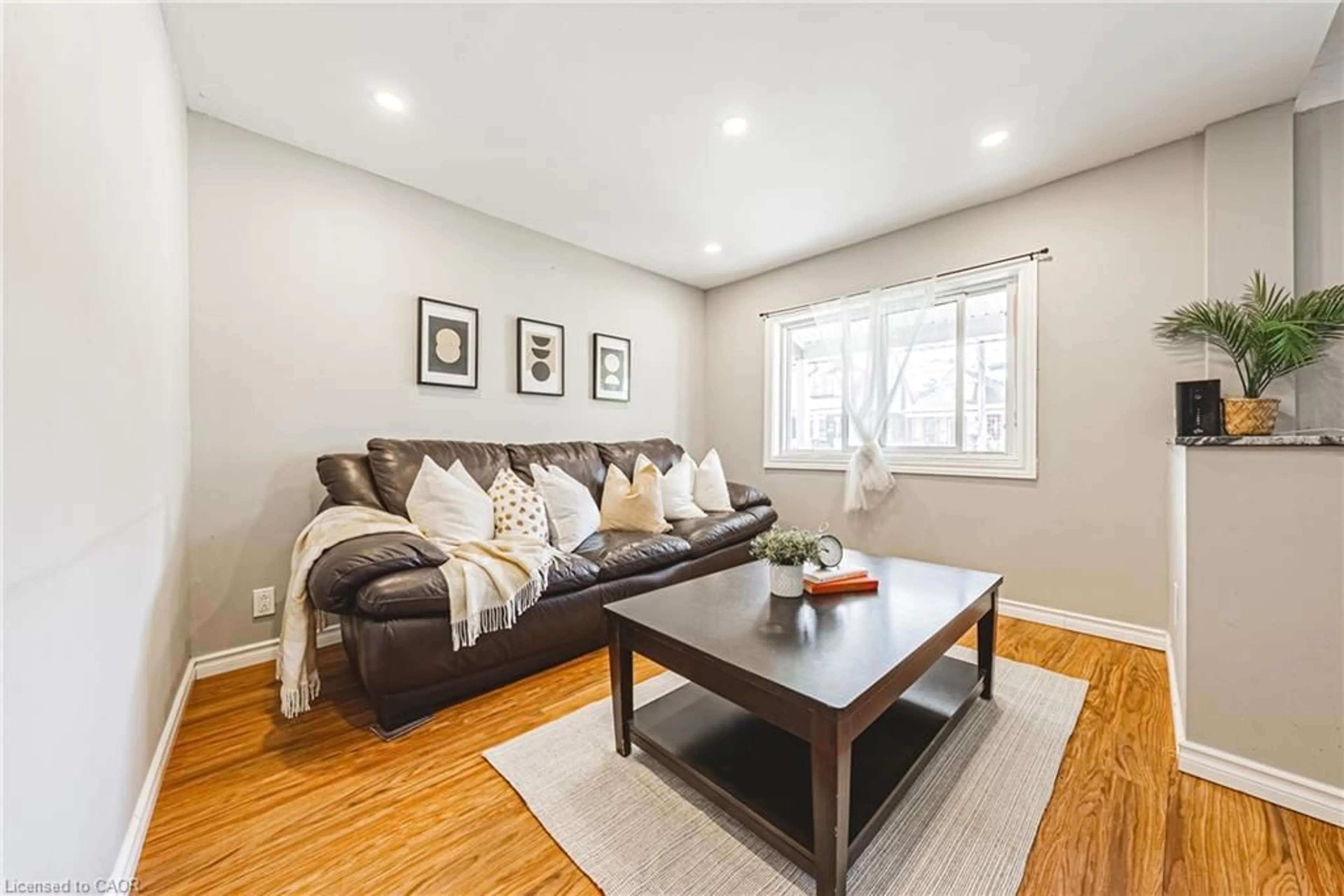 Living room with furniture, wood/laminate floor for 24 Rowanwood St, Hamilton Ontario L8L 7H3