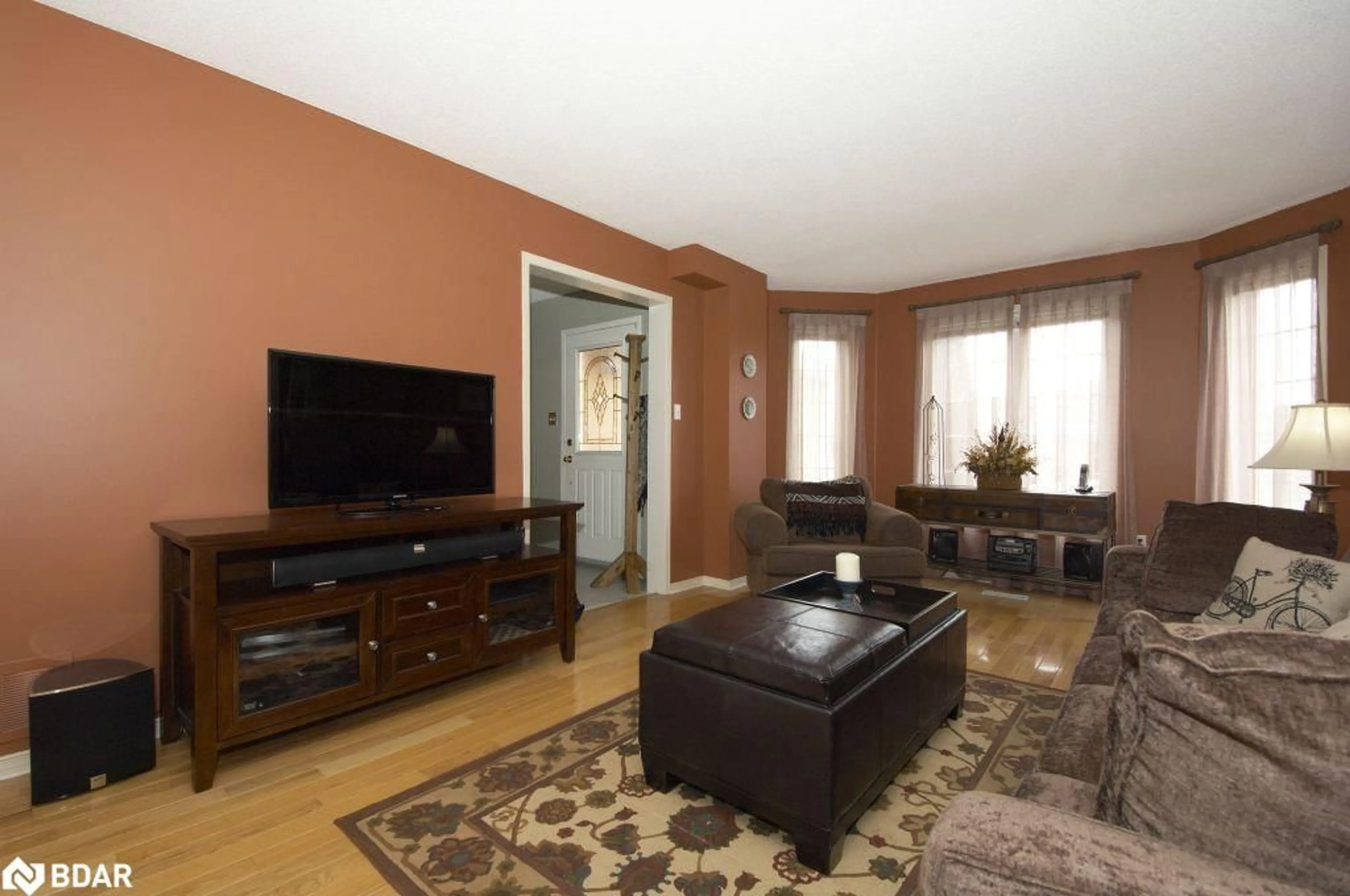 Living room with furniture, wood/laminate floor for 7 Teal Pl, Barrie Ontario L4N 8W1