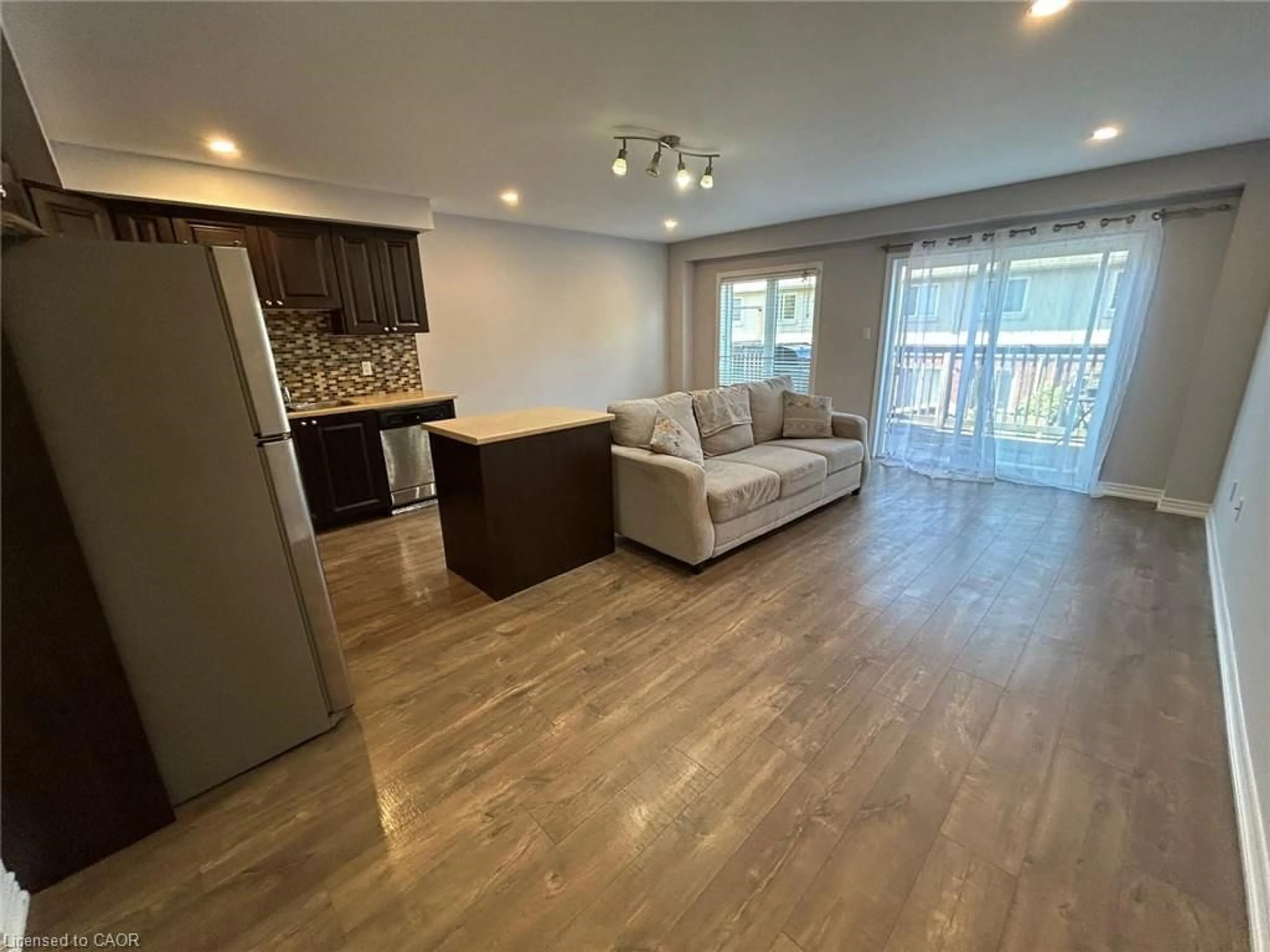 Living room with furniture, wood/laminate floor for 20 Mcconkey Cres #79, Brantford Ontario N3S 0C1