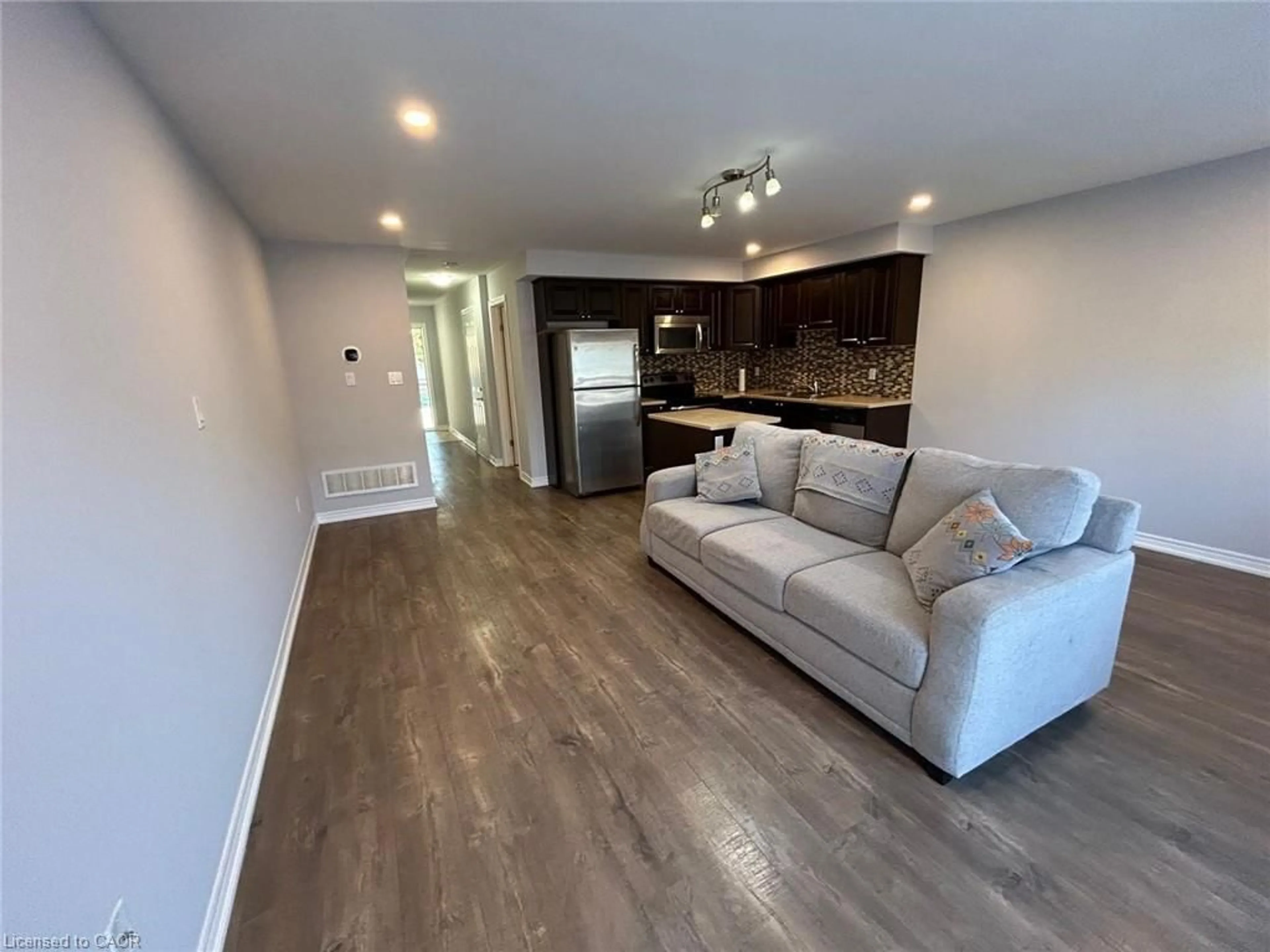 Living room with furniture, wood/laminate floor for 20 Mcconkey Cres #79, Brantford Ontario N3S 0C1