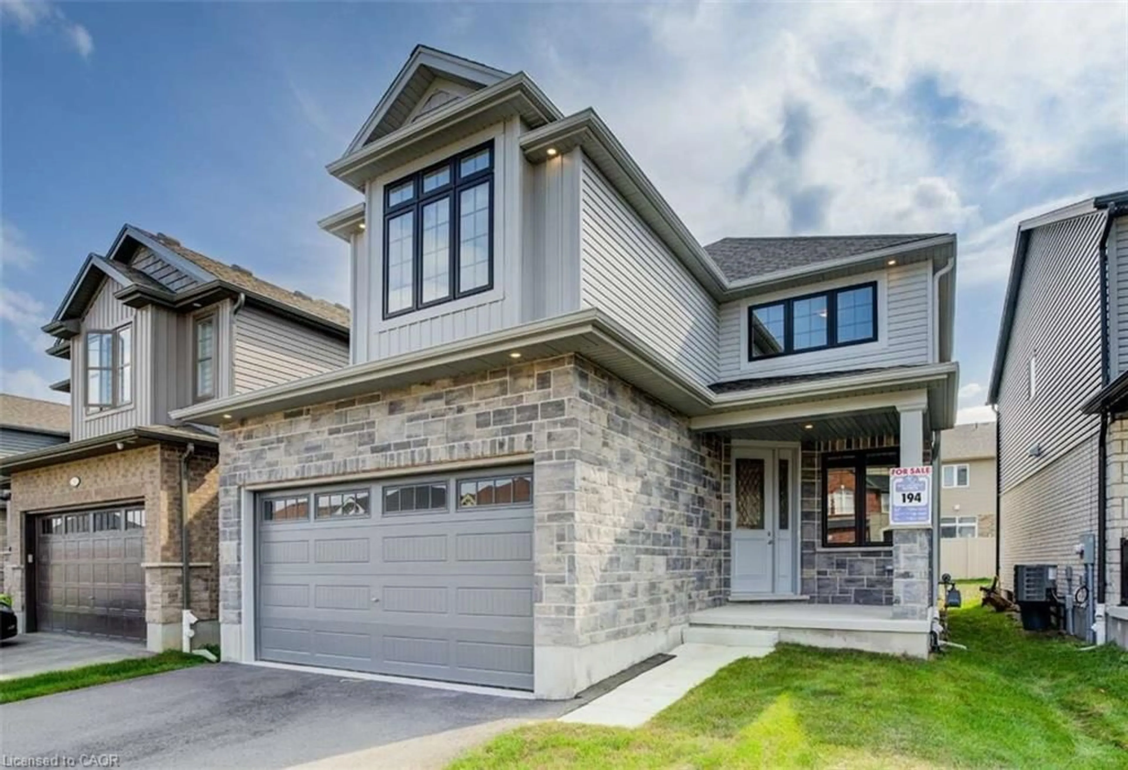 Home with brick exterior material, street for 83 Crosswinds Dr, Kitchener Ontario N2A 0J9