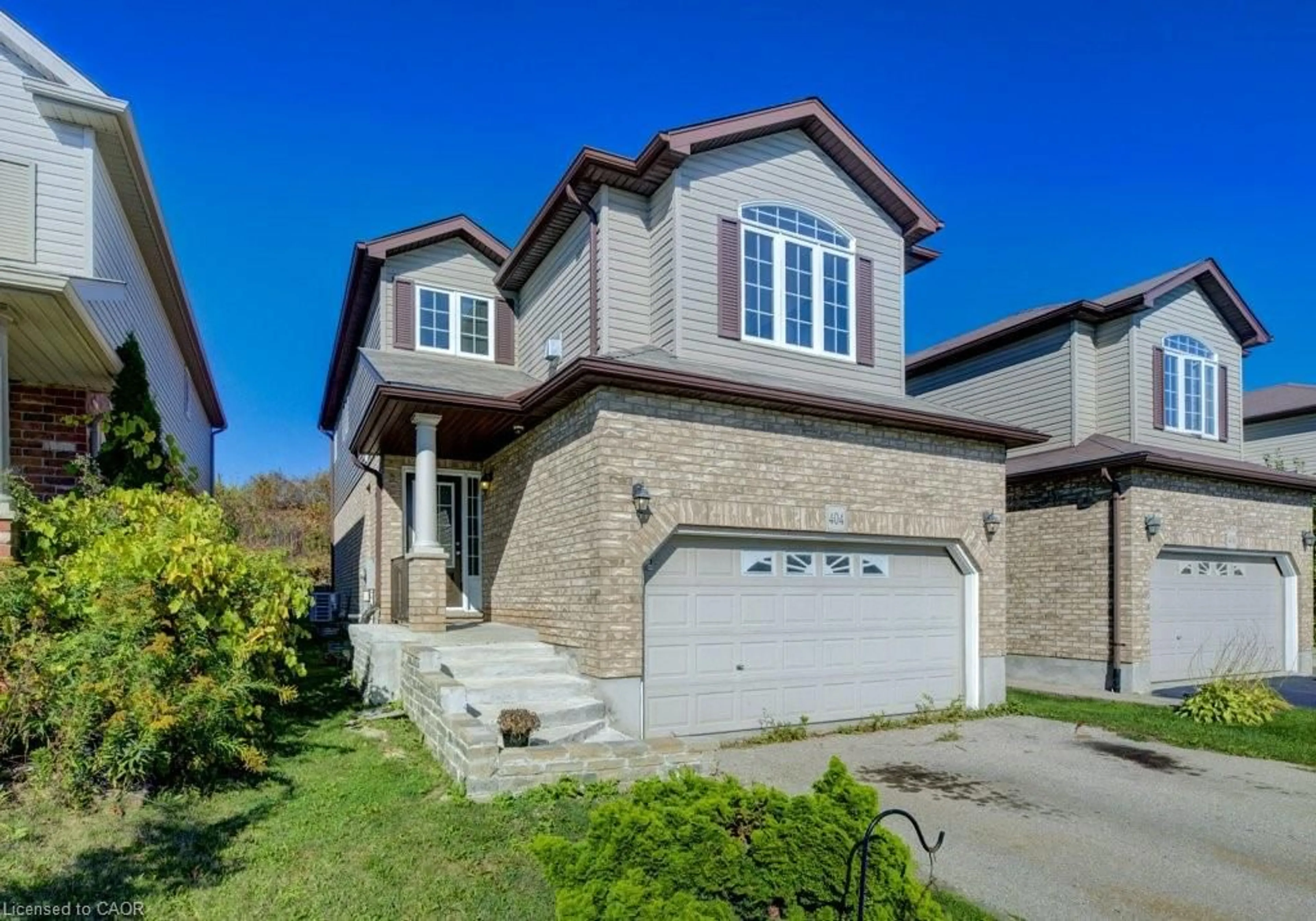 Home with brick exterior material, street for 404 Tealby Cres, Waterloo Ontario N2J 4Y8