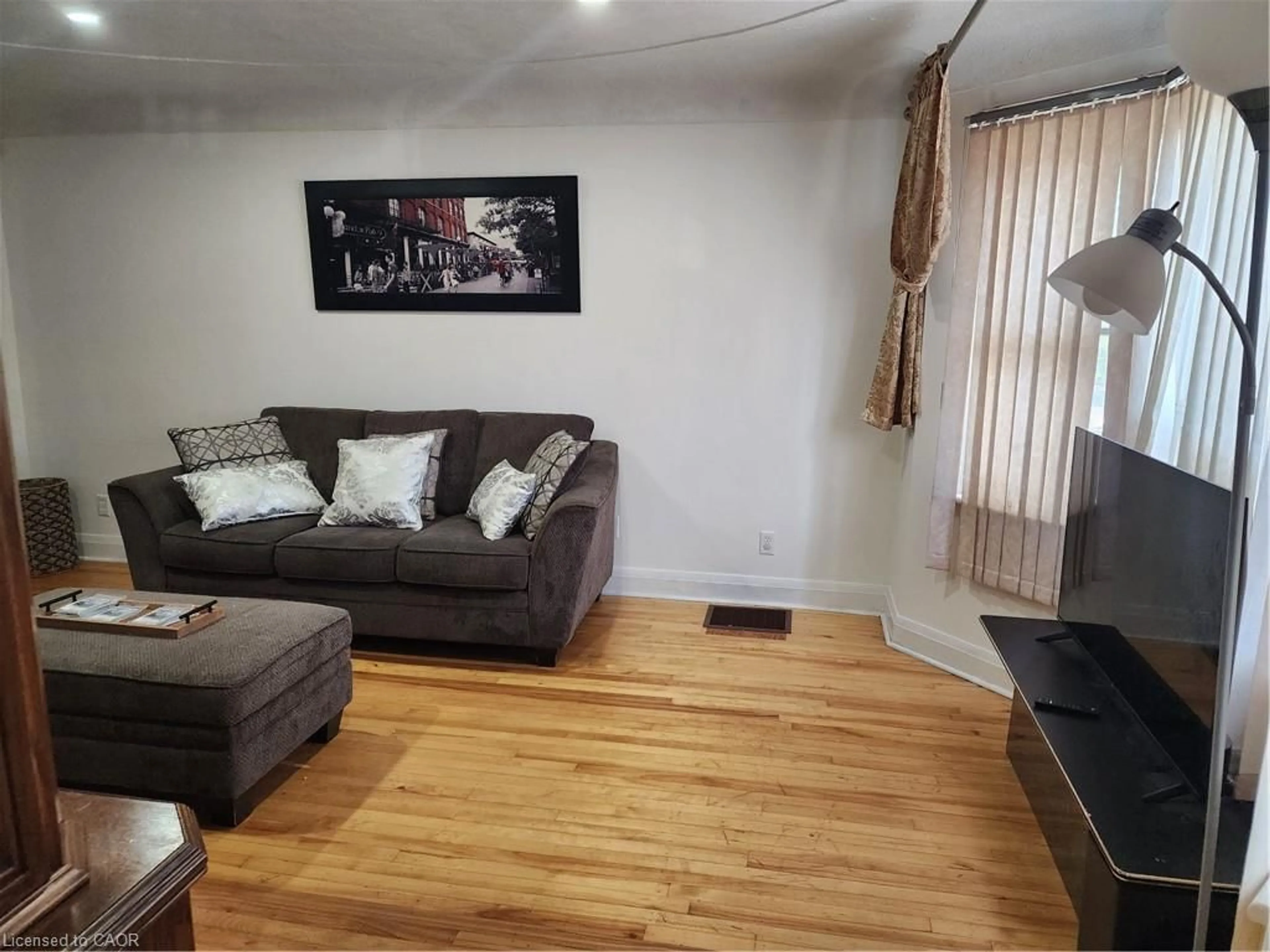 Living room with furniture, wood/laminate floor for 199 Stirton St, Hamilton Ontario L8L 6G7