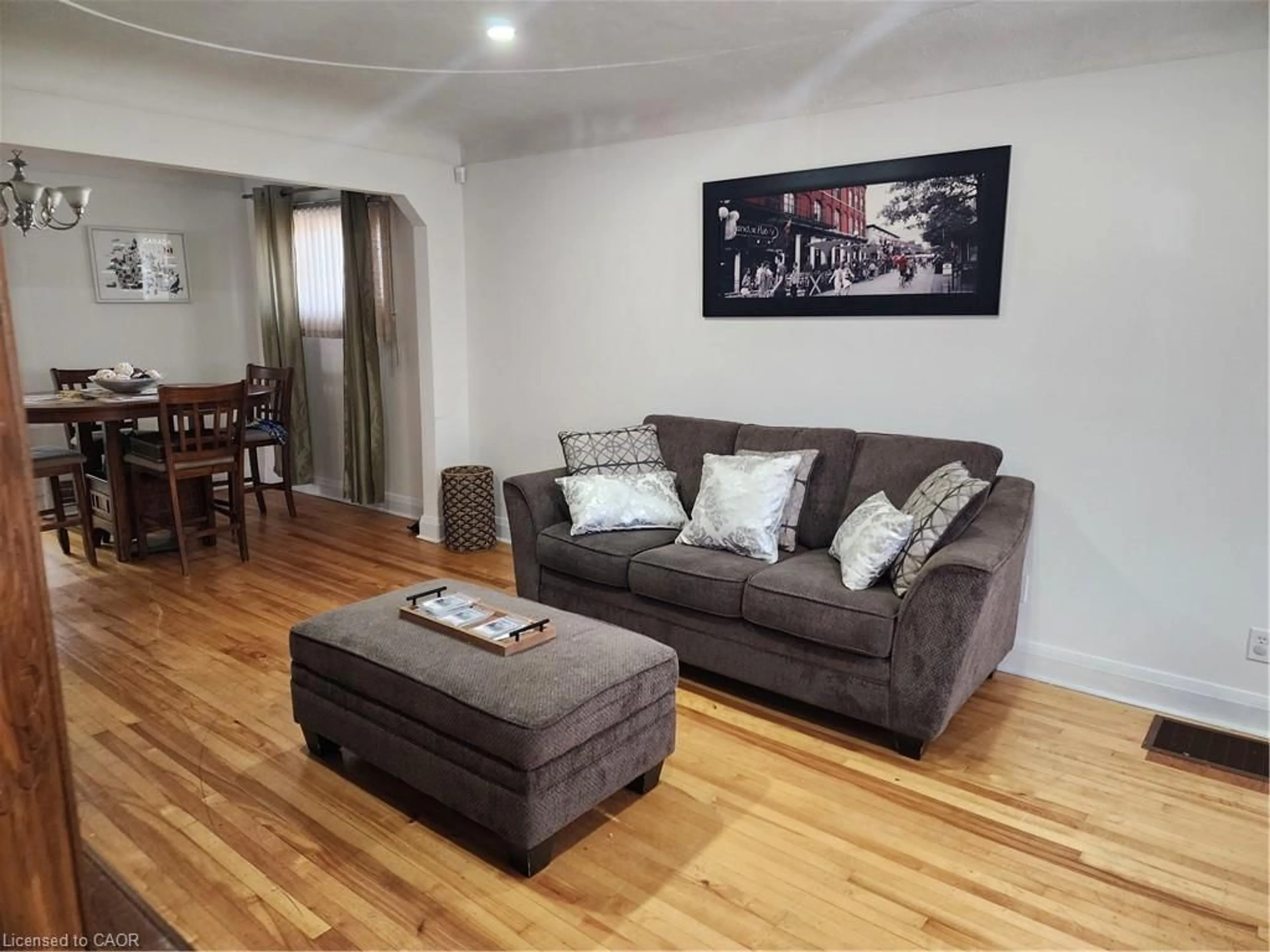 Living room with furniture, wood/laminate floor for 199 Stirton St, Hamilton Ontario L8L 6G7