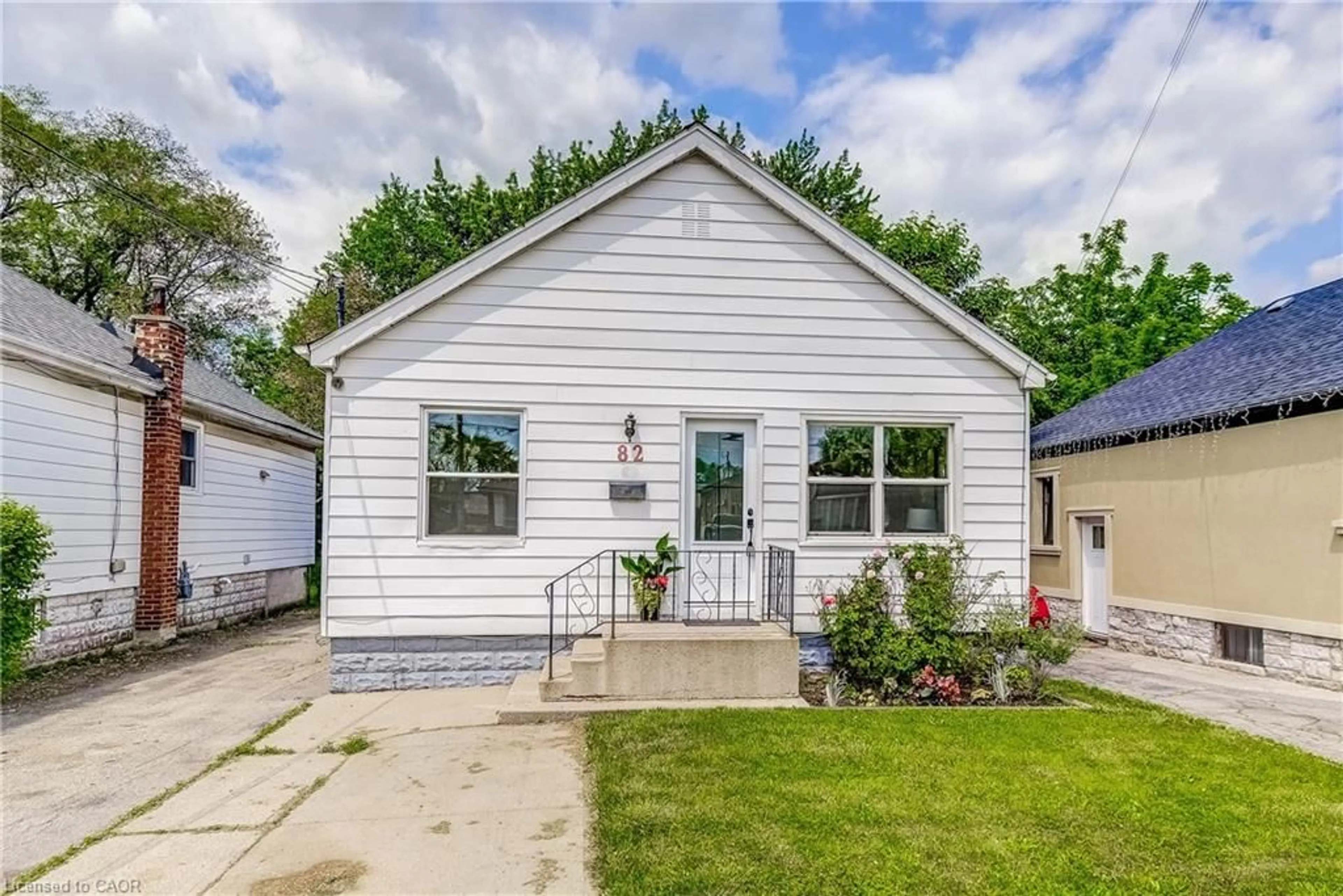 Home with vinyl exterior material, street for 82 West 1st St, Hamilton Ontario L9C 3C4