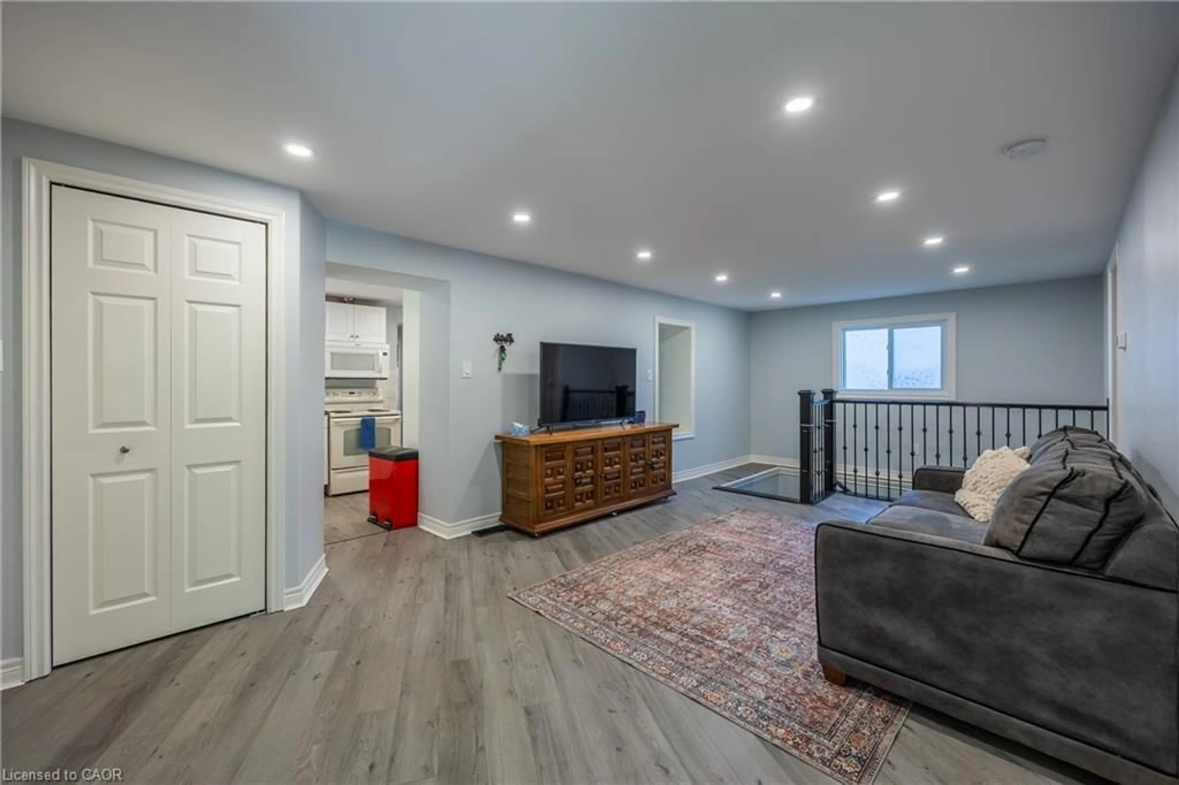 Living room with furniture, wood/laminate floor for 32 Wade Ave, Brantford Ontario N3T 1W8