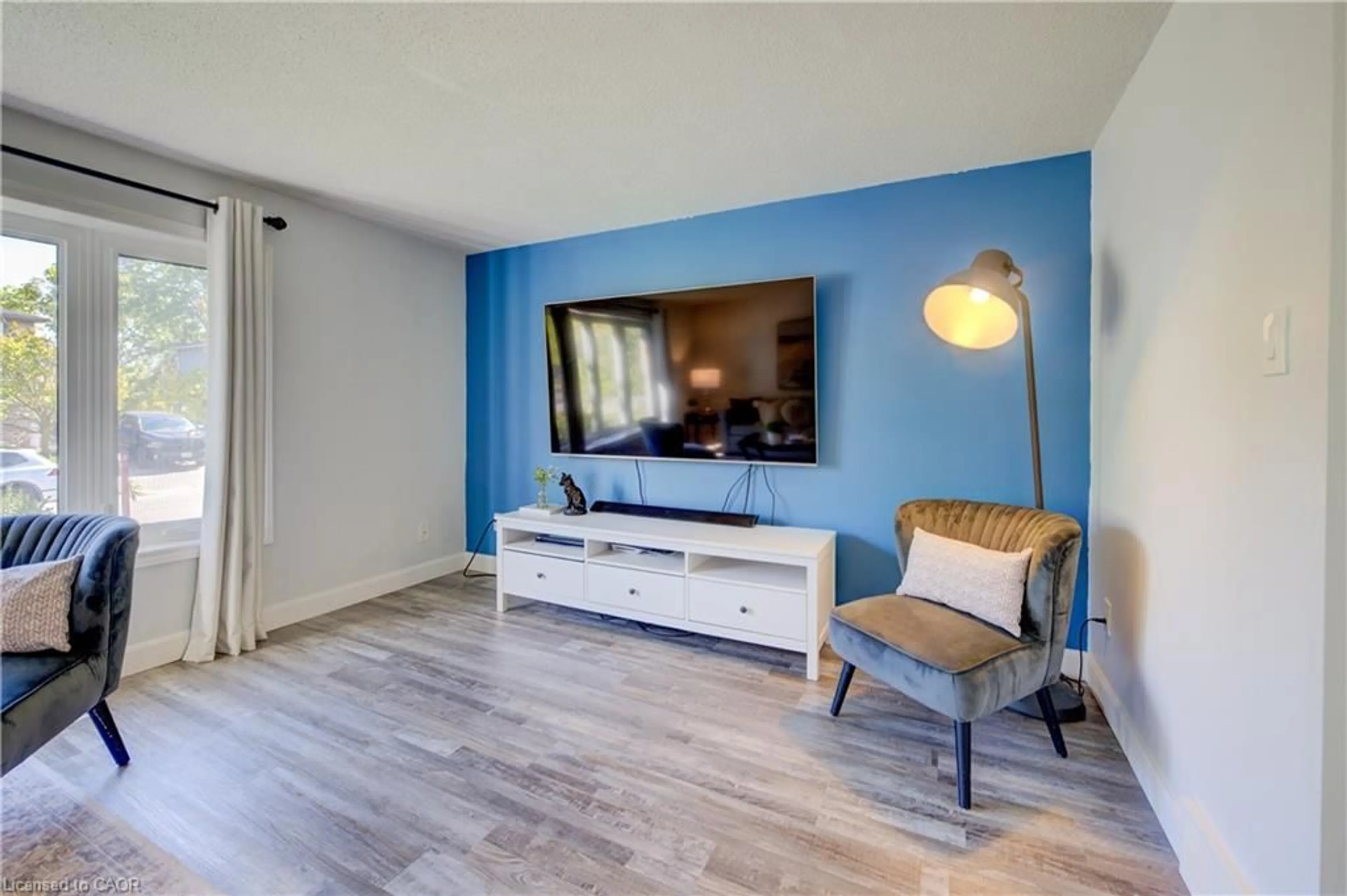 Living room with furniture, wood/laminate floor for 24 Caprice Crt, Kitchener Ontario N2M 5M2