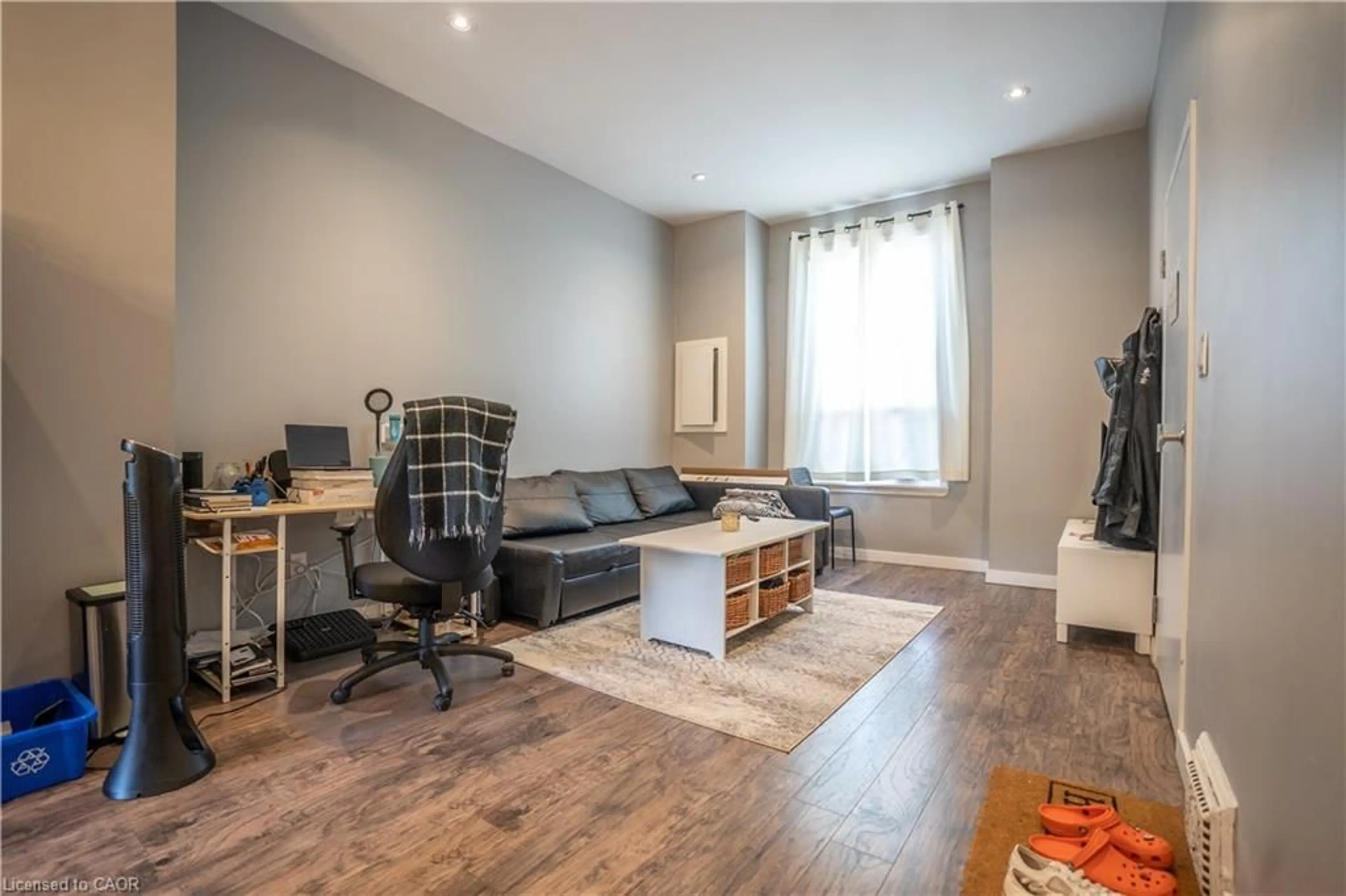 Living room with furniture, wood/laminate floor for 165 Emerald St, Hamilton Ontario L8L 5K9