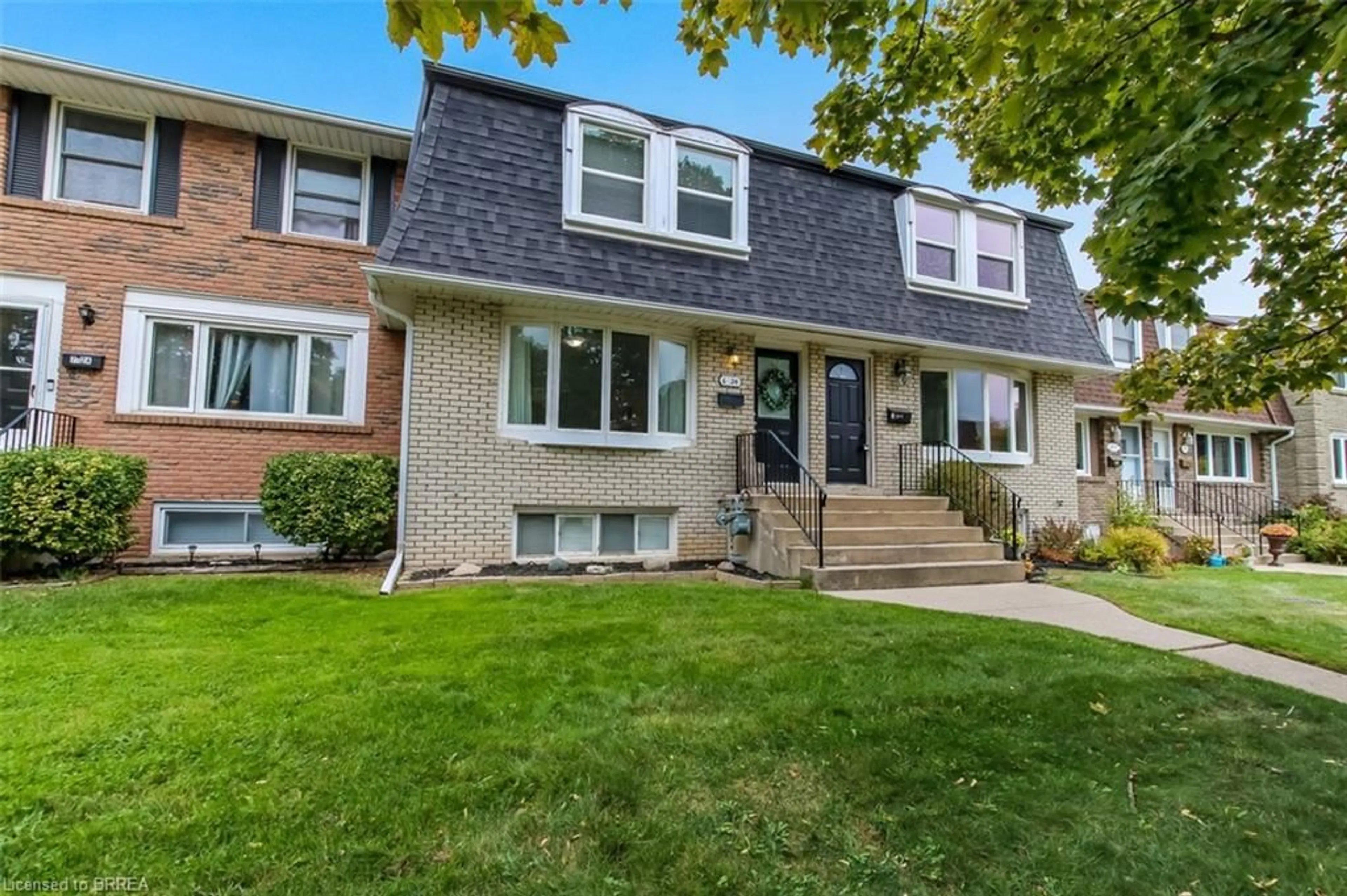 Home with vinyl exterior material, street for 24 Coachwood Rd #6, Brantford Ontario N3R 3R4