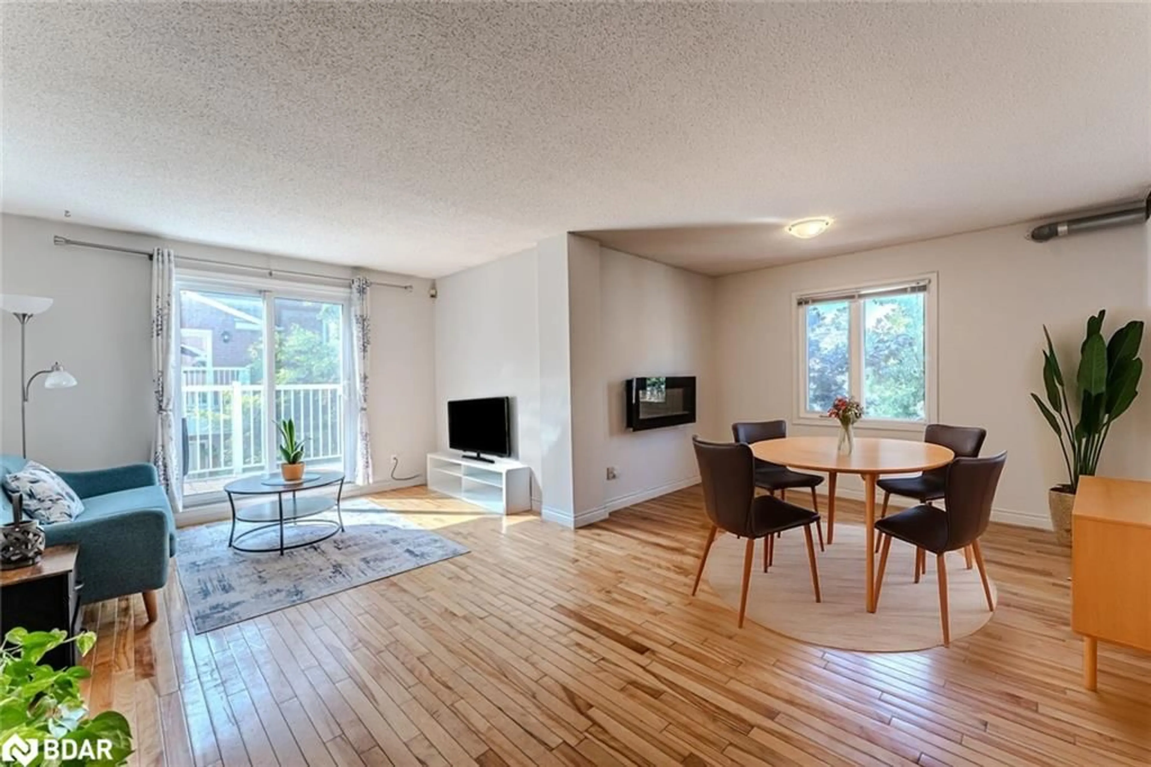 Living room with furniture, wood/laminate floor for 508 Essa Road #52, Barrie Ontario L4N 7L5