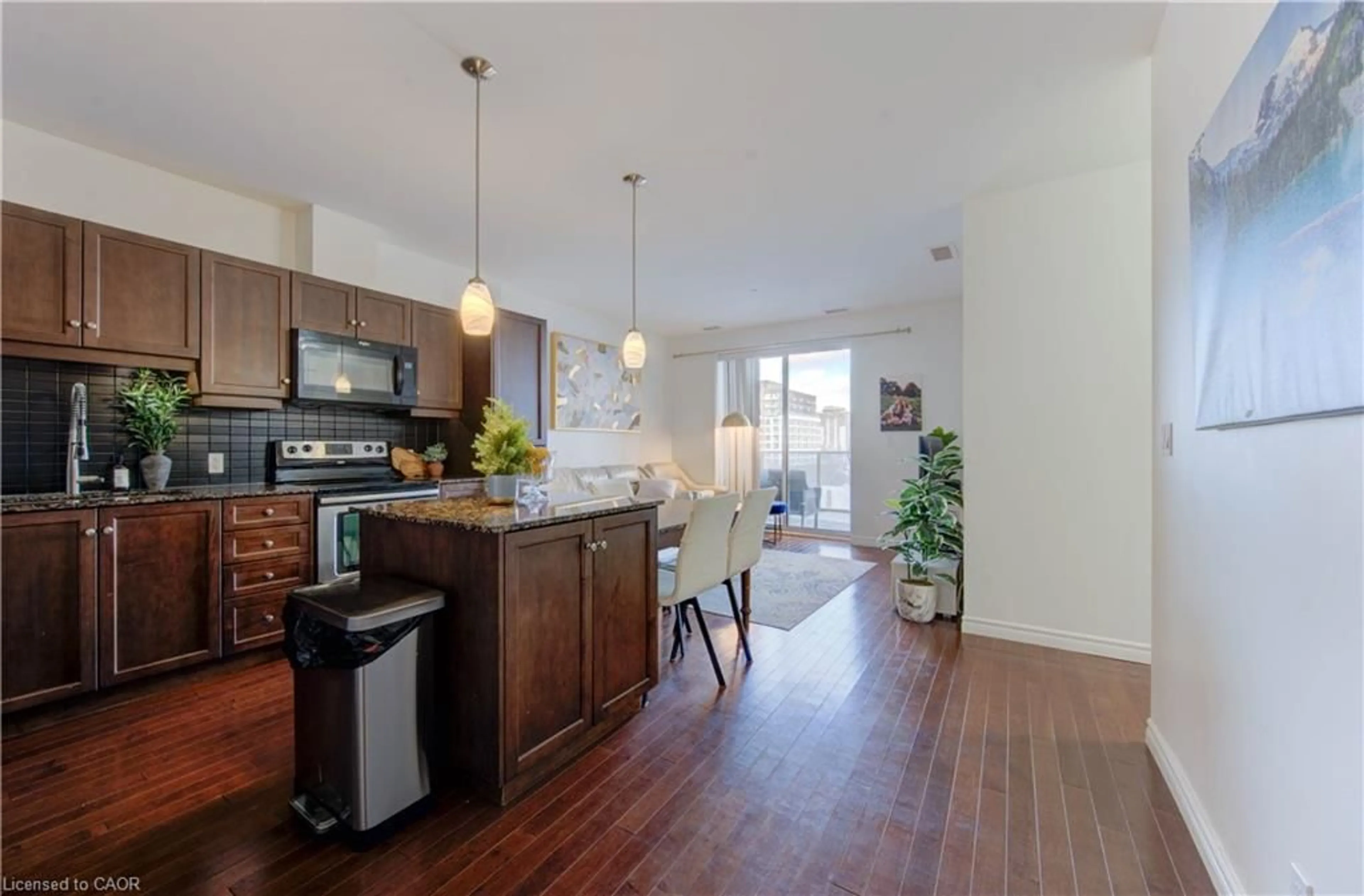 Open concept kitchen, wood/laminate floor for 223 Erb St #405, Waterloo Ontario N2L 0B3