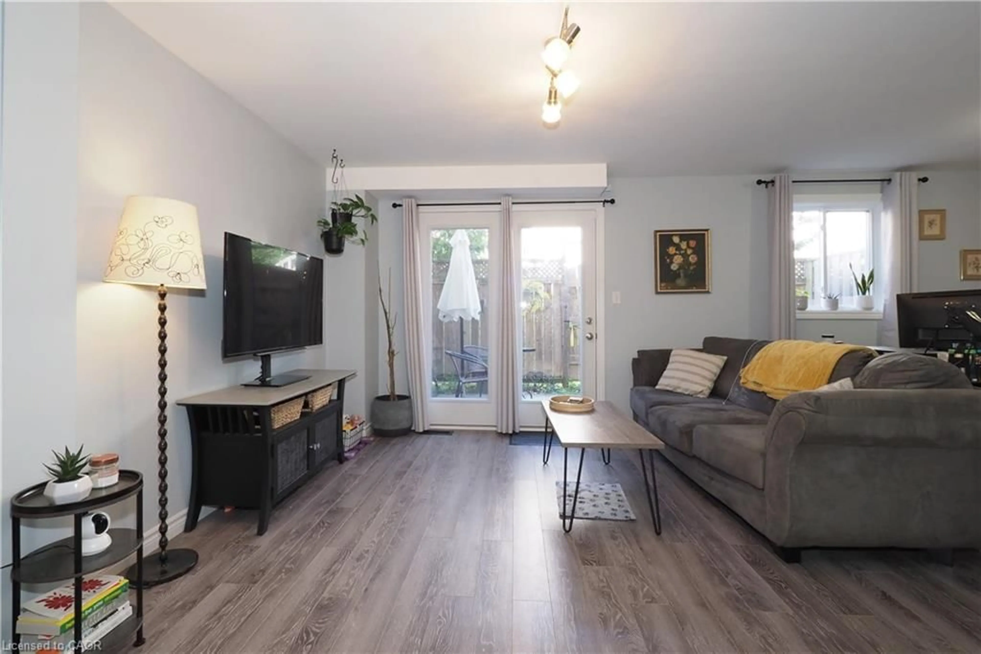 Living room with furniture, wood/laminate floor for 55 Mooregate Cres #12A, Kitchener Ontario N2M 0A6