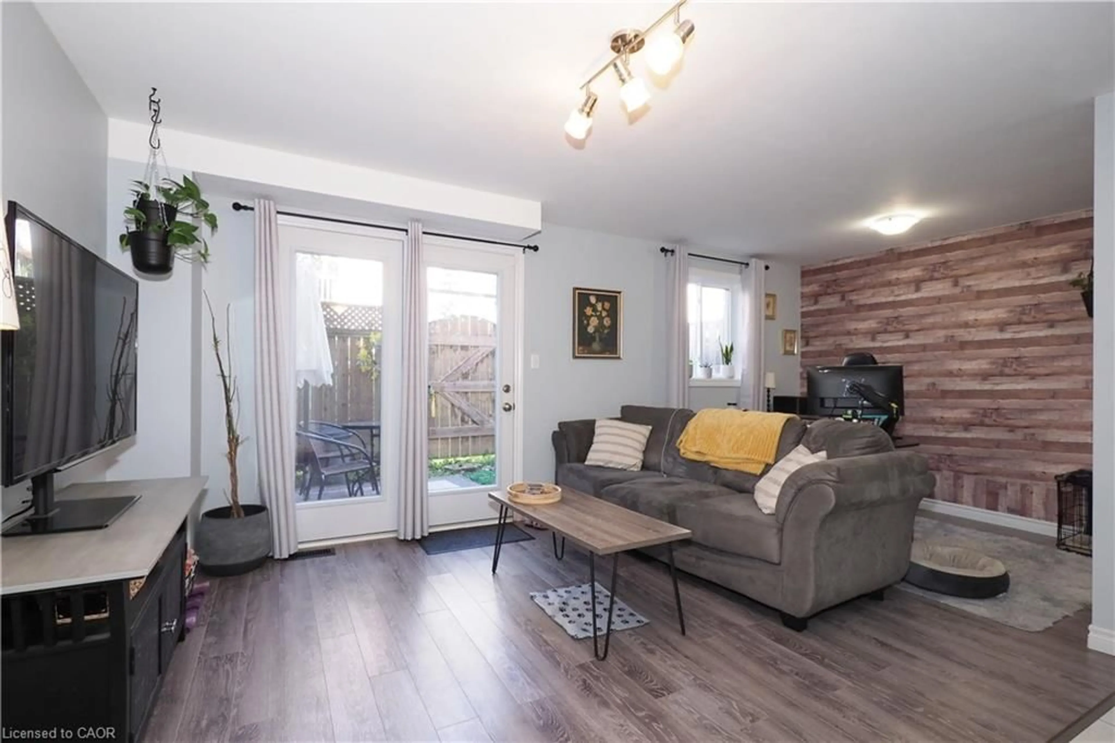 Living room with furniture, wood/laminate floor for 55 Mooregate Cres #12A, Kitchener Ontario N2M 0A6