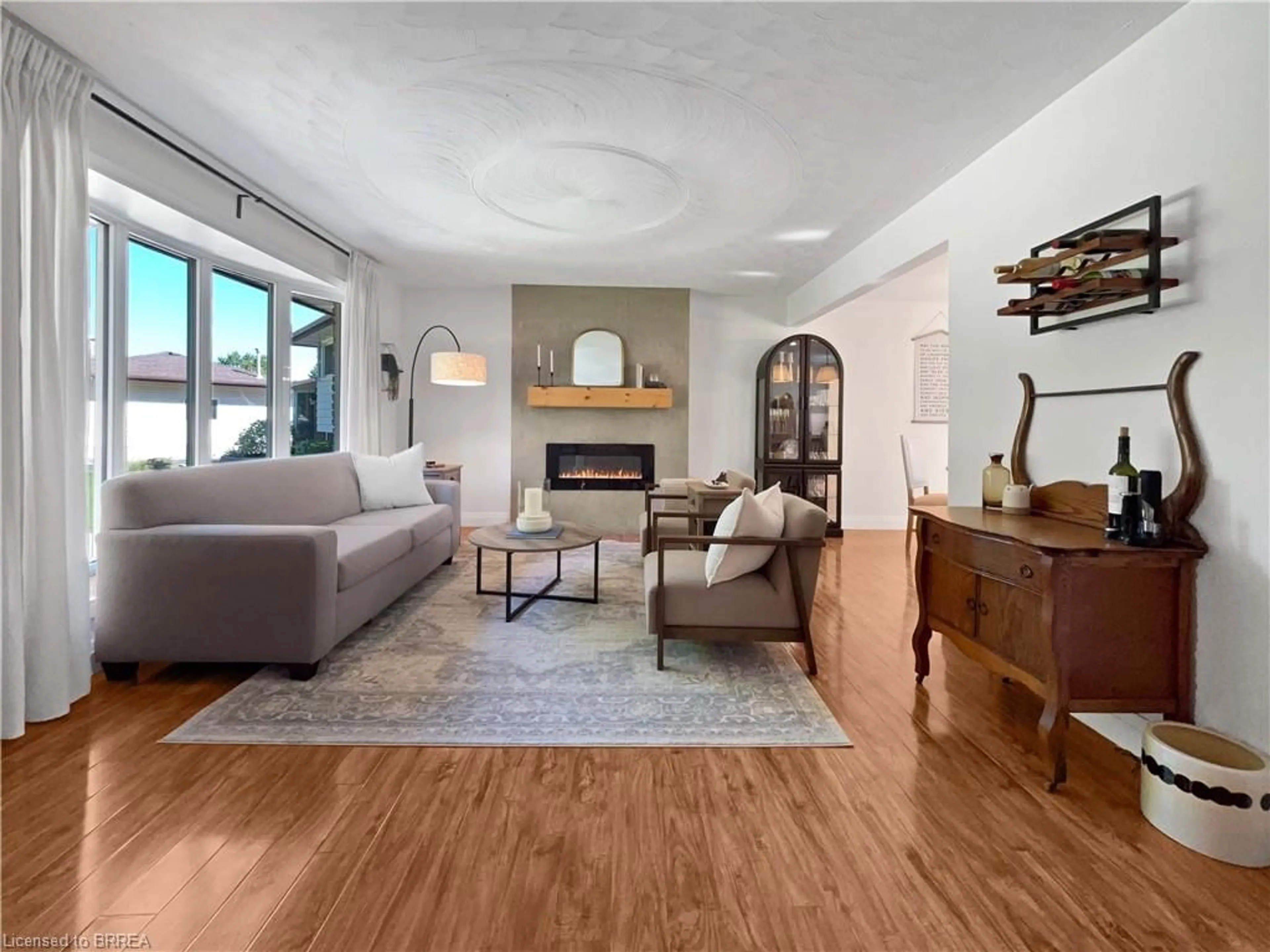 Living room with furniture, wood/laminate floor for 9 Normandy Cir, Simcoe Ontario N3Y 4J6