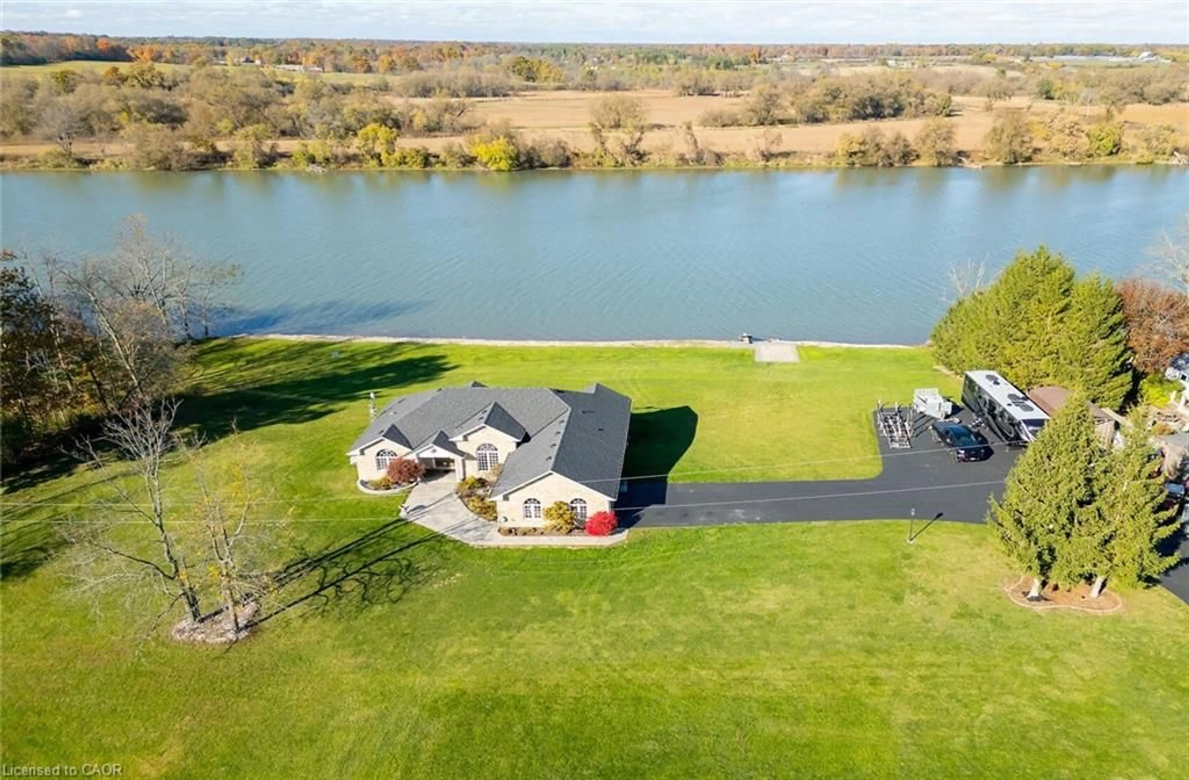 A pic from outside/outdoor area/front of a property/back of a property/a pic from drone, water/lake/river/ocean view for 1140 River Rd, Cayuga Ontario N0A 1E0