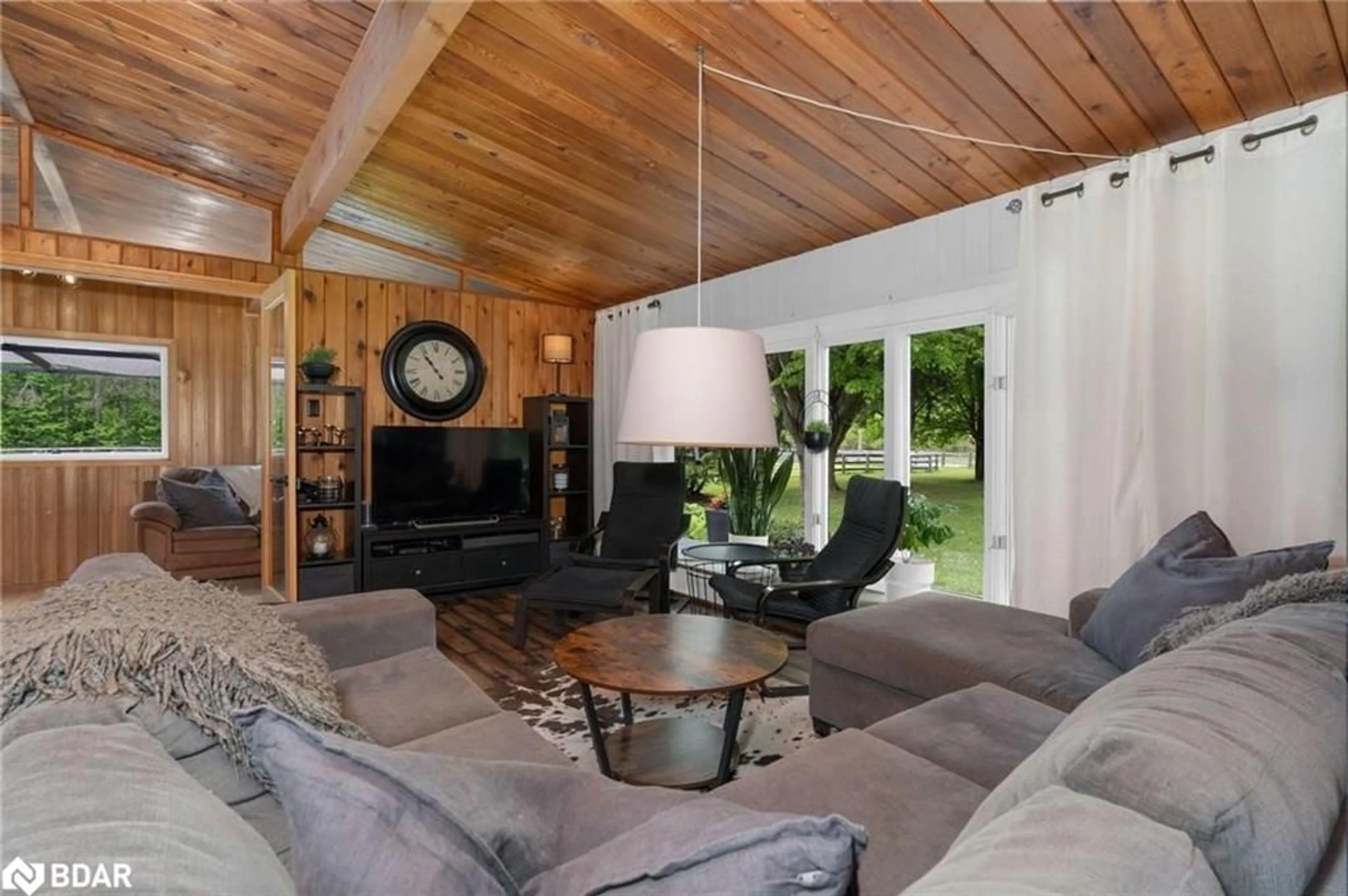 Living room with furniture, wood/laminate floor for 1398 Old Second Road North Rd, Springwater Ontario L0L 2K0