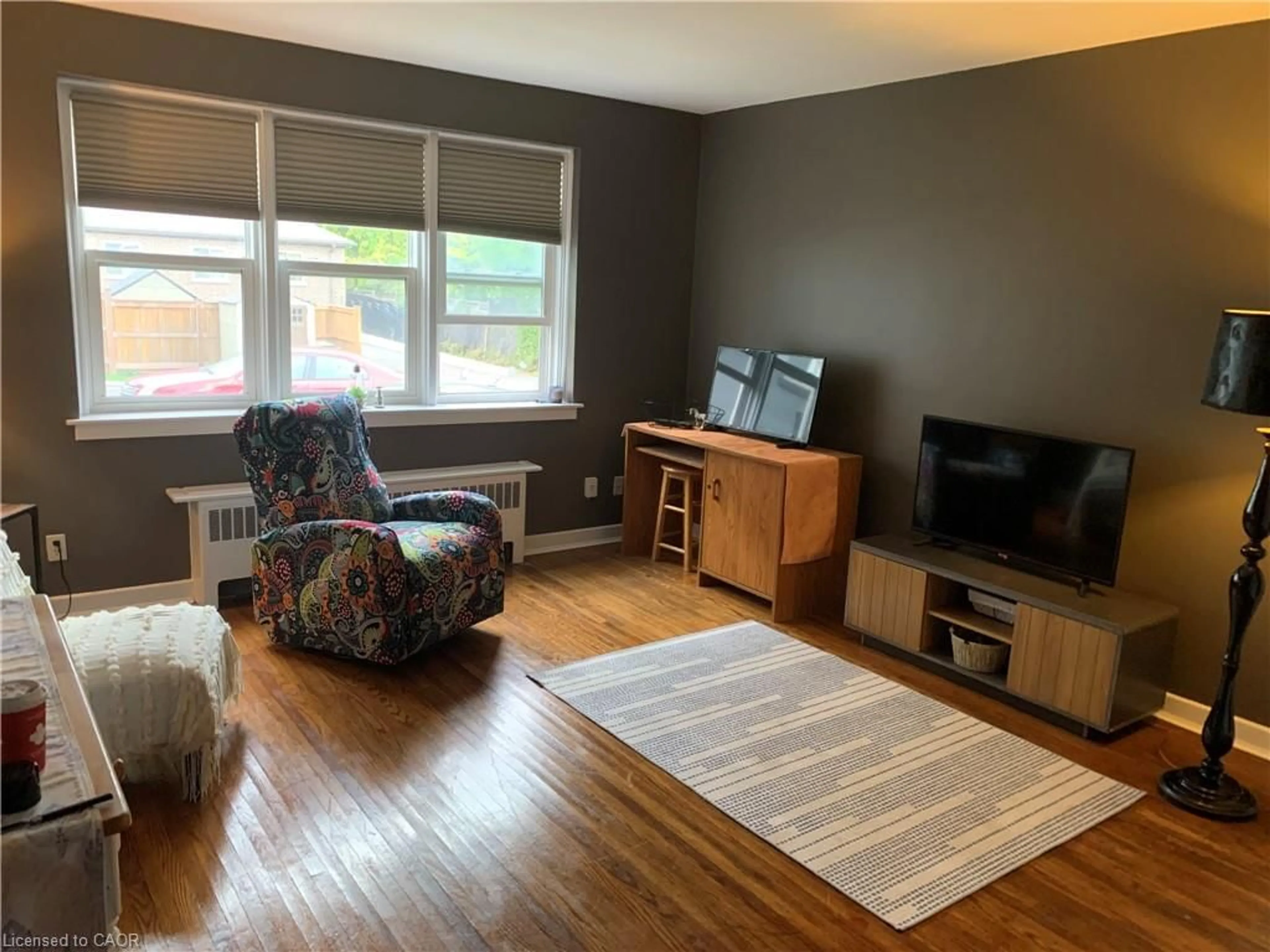 Living room with furniture, wood/laminate floor for 1759 King St #33, Hamilton Ontario L8K 1V6