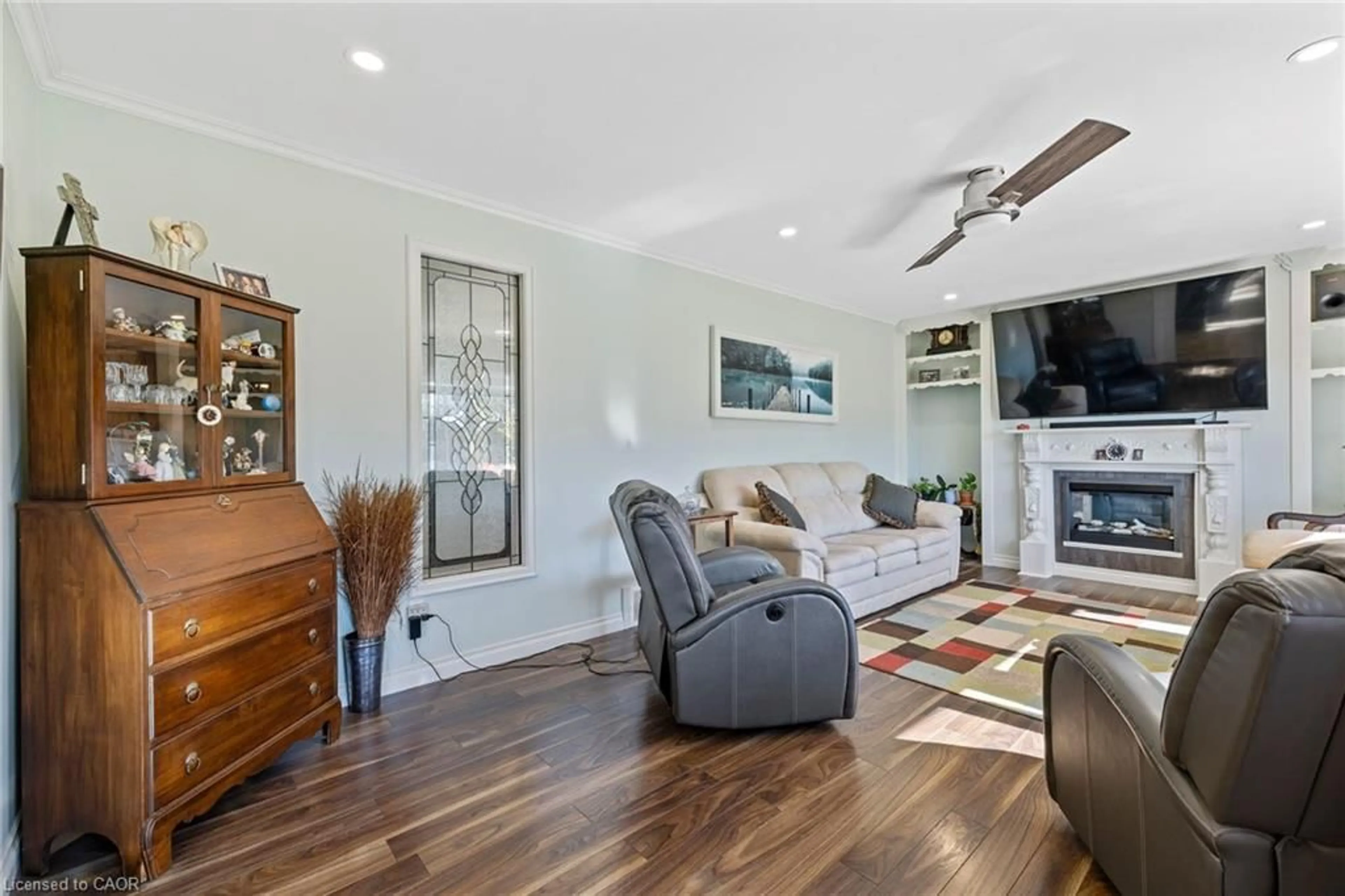 Living room with furniture, wood/laminate floor for 1637 Windham Road 7, R. R. #3 Rd, Vanessa Ontario N0E 1V0