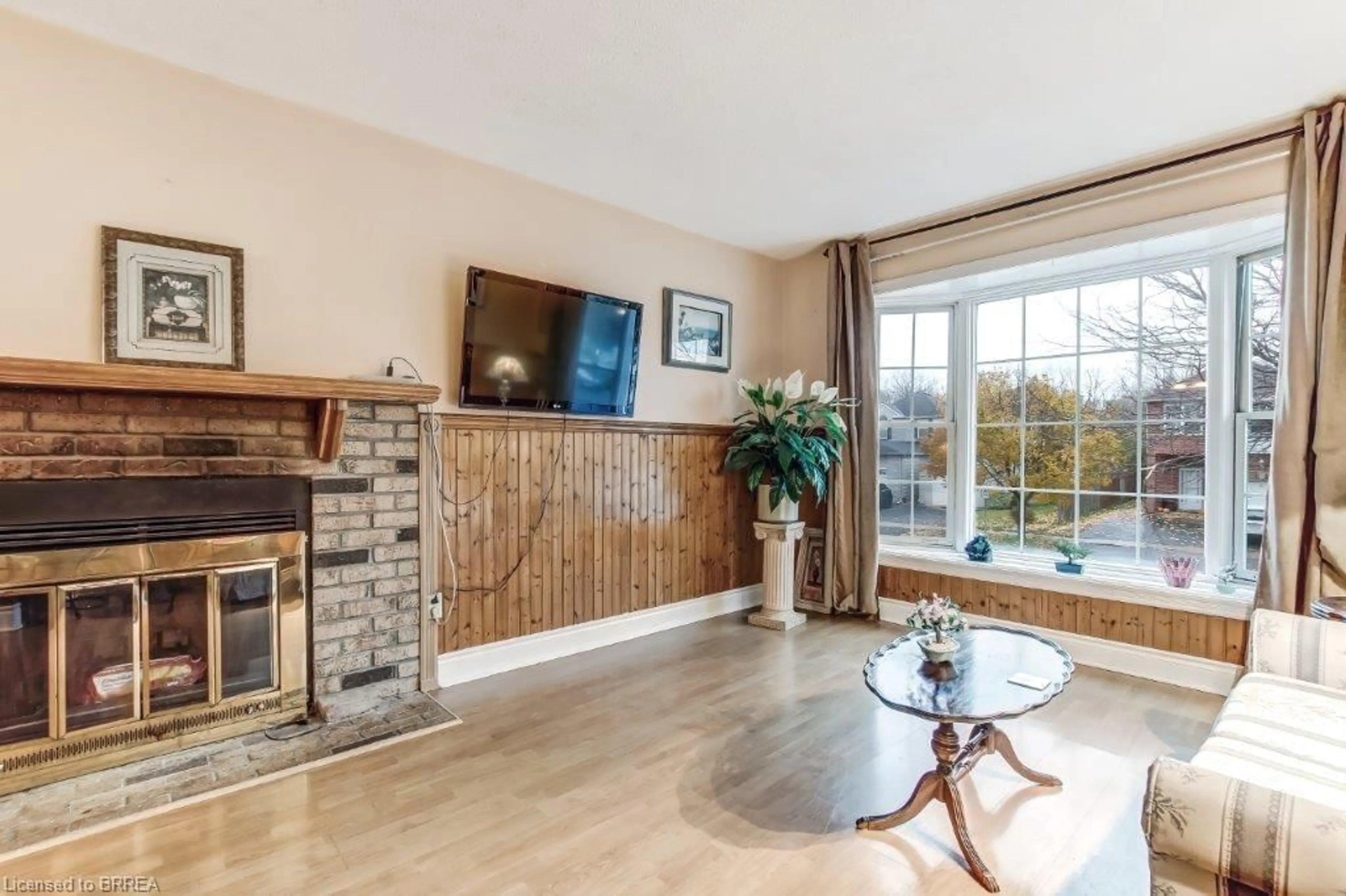 Living room with furniture, wood/laminate floor for 66 D'aubigny Rd, Brantford Ontario N3T 6J3